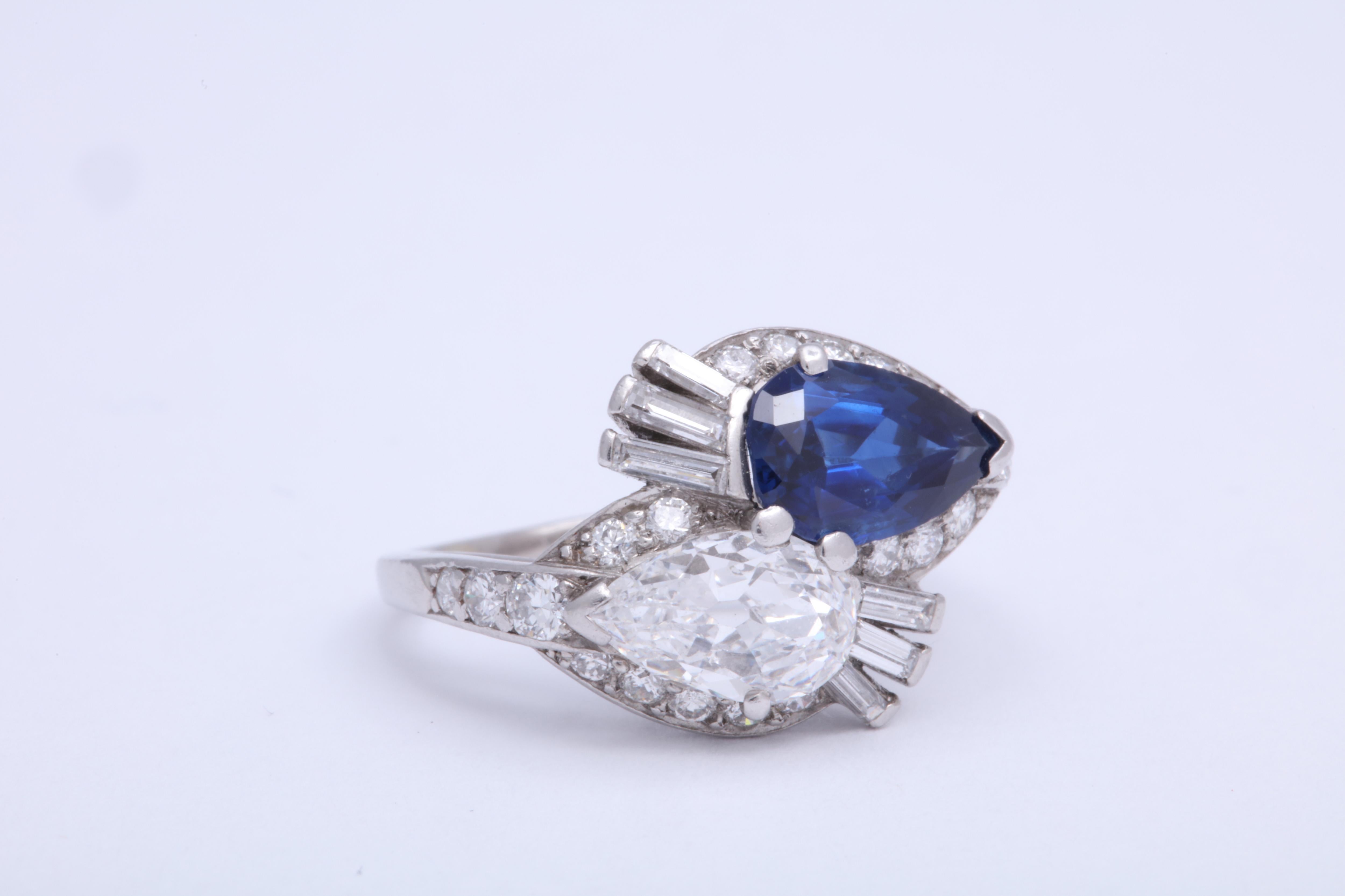 Made by Bailey, Banks, and Biddle in Philadelphia c. 1935. The pear shaped sapphire weighs approximately 1.5cts. The pear shaped diamond weighs approximately .85cts. 6 baguette and 21 brilliant cut diamonds surround the two center stones. Total