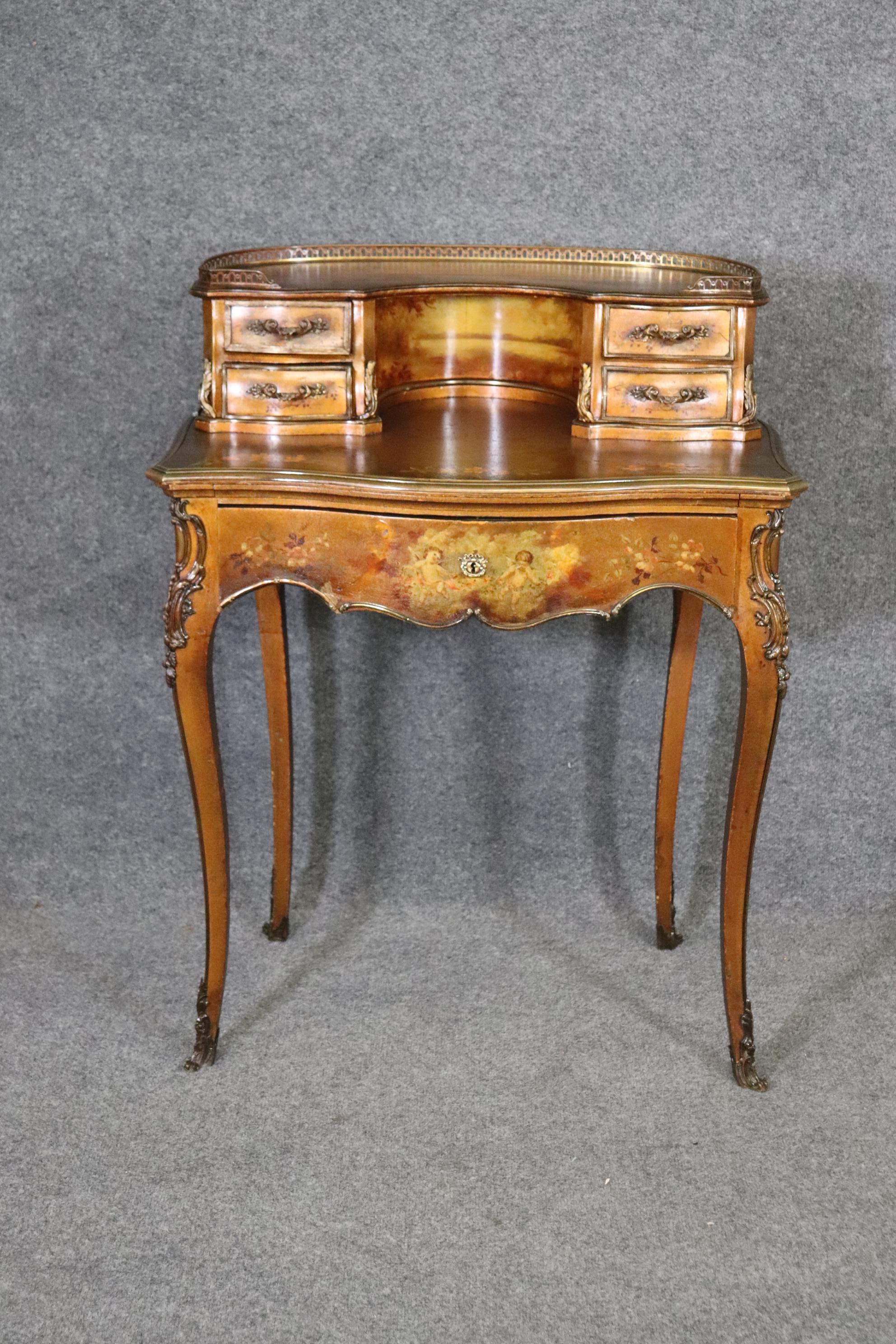 This is a fantastic French-made Vernis Martin Paint decorated writing desk made for Bailey Banks & Biddle - the Tiffany of Philadelphia, PA. The desk is beautifully hand-painted with the typical Venris Martin scenes but done on a gold gilded