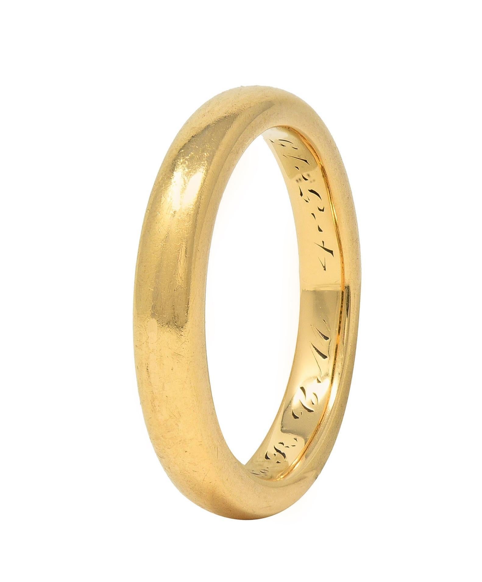 Designed as a sleek high polish gold band 
With rounded edges 
Inscribed 'H.A.F to R.C.M 4-5-15'
Stamped for 18 karat gold
With maker's mark for Bailey Banks & Biddle
Circa: 1915; via dated inscription
Ring Size: 5 1/4 - inquire for sizing
Measures