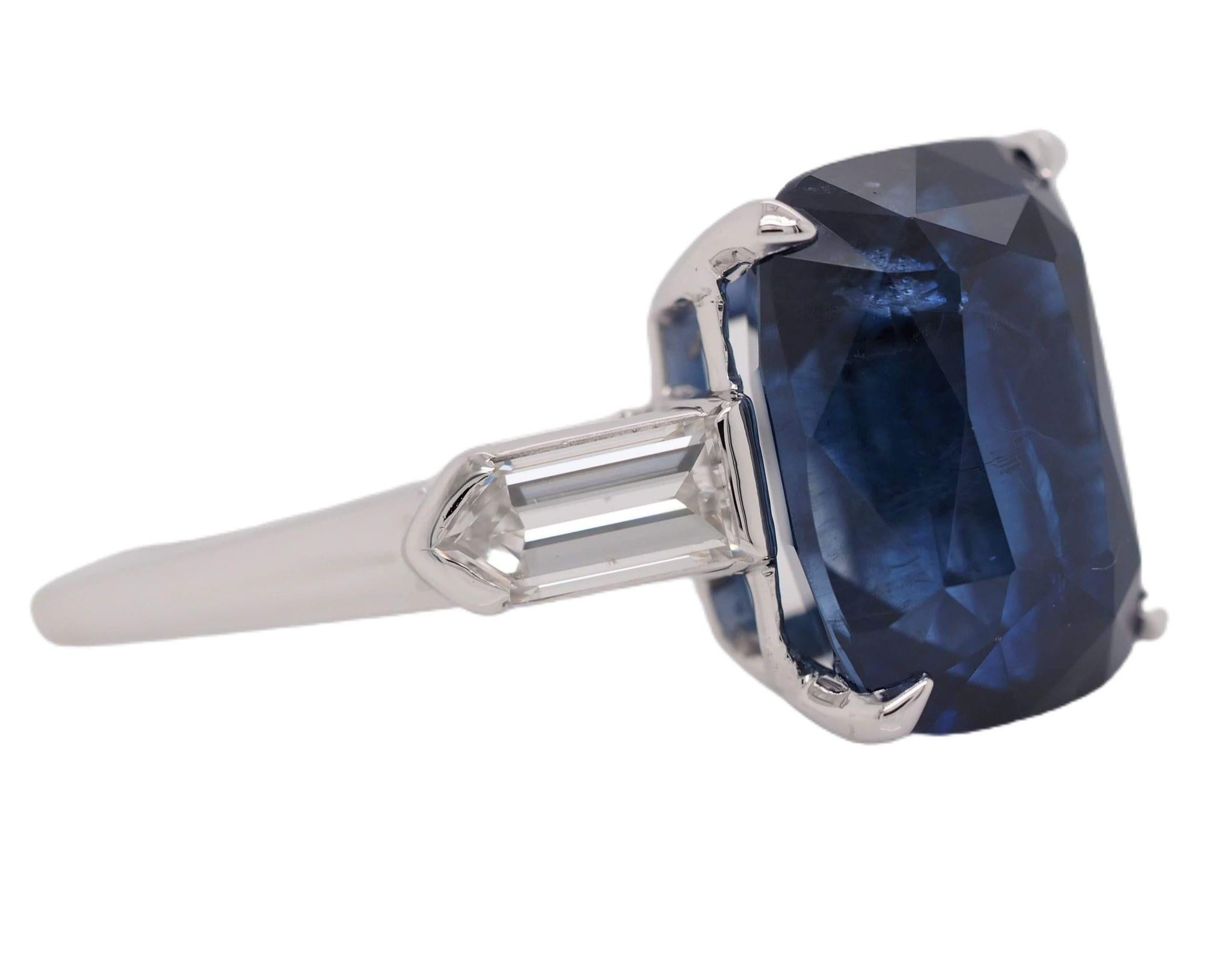 This Bailey Banks & Biddle sapphire ring is fresh off of the jewelers bench. The center stone is a natural GIA Certified 6.97 carat Cushion Cut blue sapphire. It is accented with two bullet cut diamonds weighing 0.74 carats total. This lovely piece