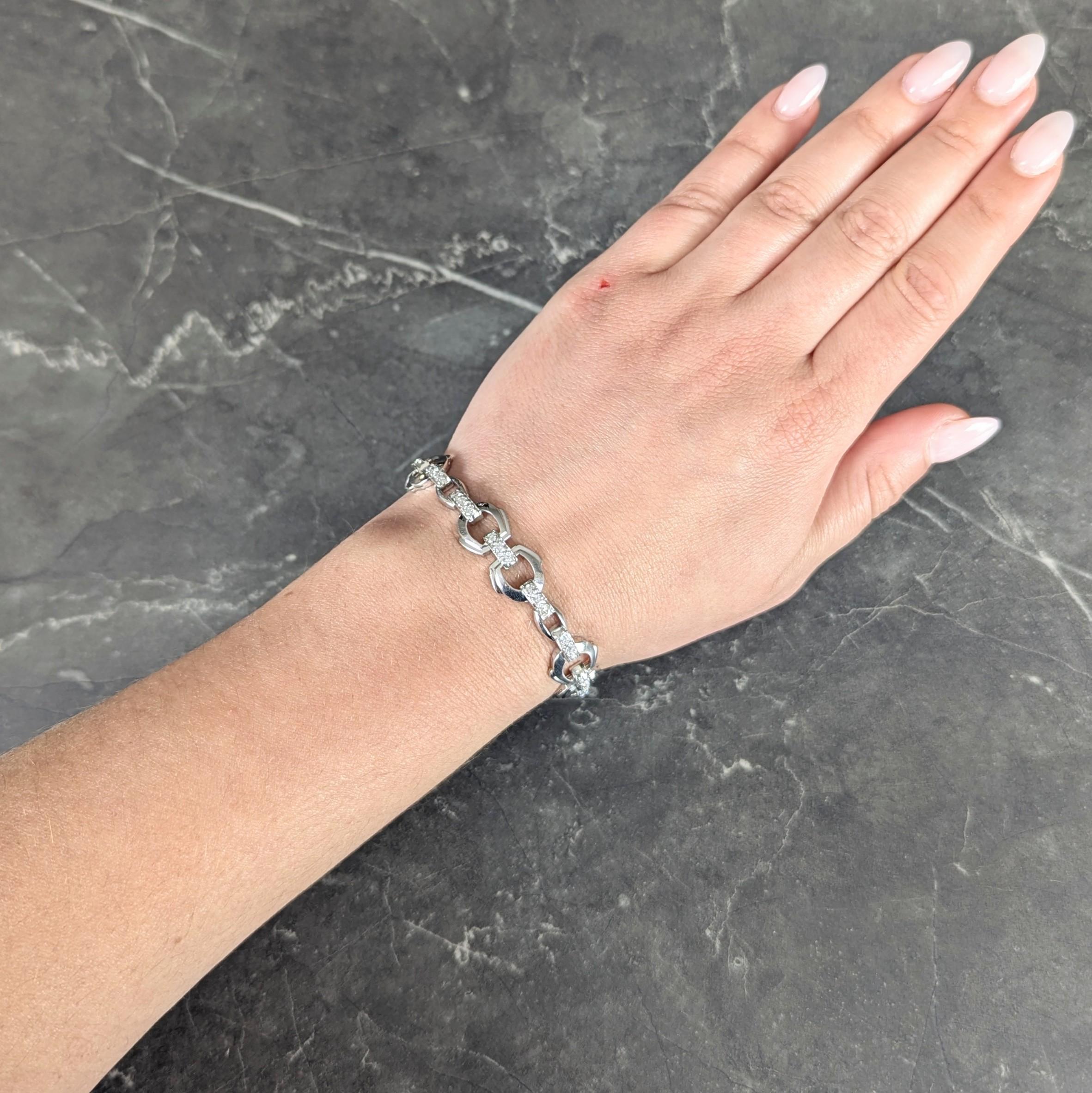 Comprised of hinged horse stirrup motif links alternating with bar links
Bar links are bead set with rows of transitional cut diamonds
Weighing approximately 2.25 carats total
G/H color with VS2 clarity
With pierced profile
Completed by concealed