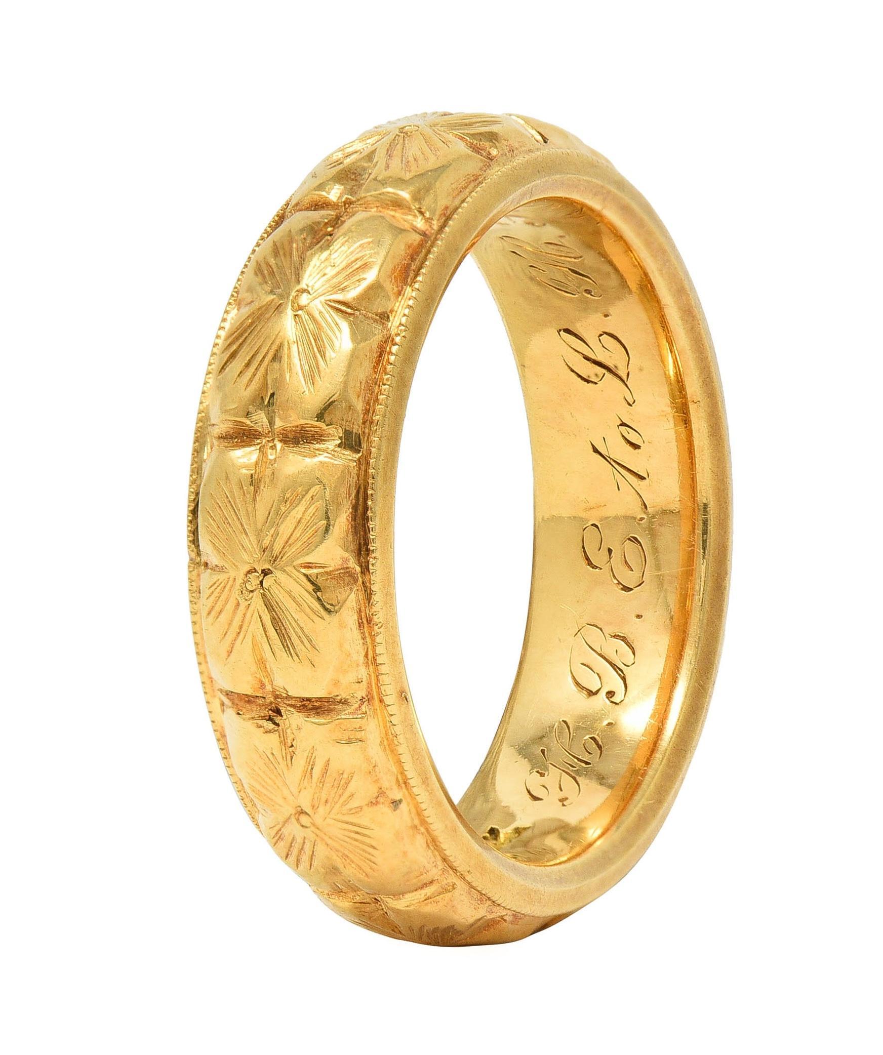 Featuring a raised orange blossom motif fully around
Accented by engraved detailing 
Flanked by milgrain edges
Inscribed 'H.B.E. to L.H.P. January 15 1908'
Stamped for 18 Karat Gold
With maker's mark for Bailey Banks & Biddle 
Circa: 1908; via dated