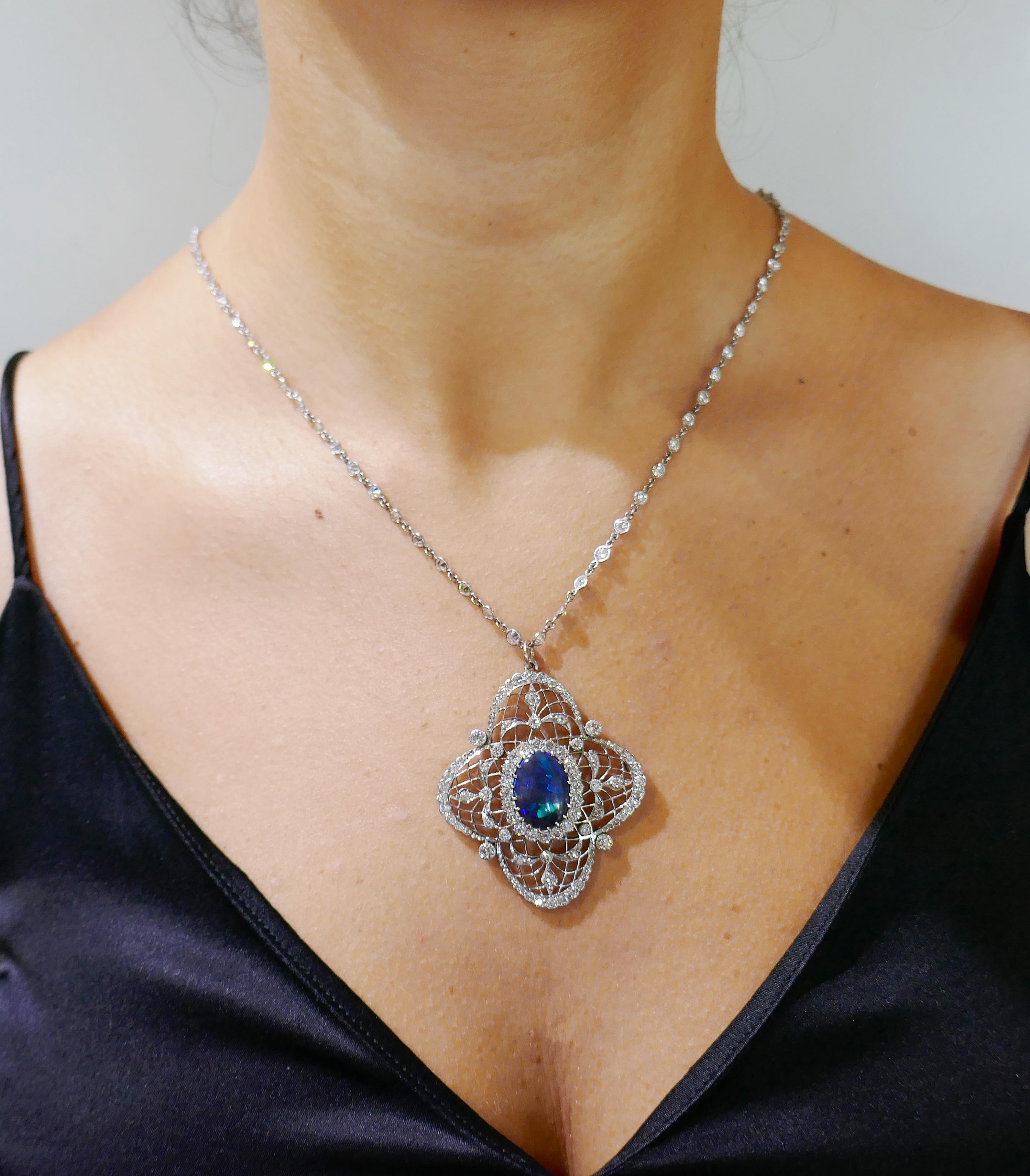 Fabulous pendant created by Bailey Banks & Biddle in the 1910s. Delicate and feminine, the pendant is a great addition to your jewelry collection. 
The pendant features an oval cabochon black opal intricately framed by Old European cut diamonds set