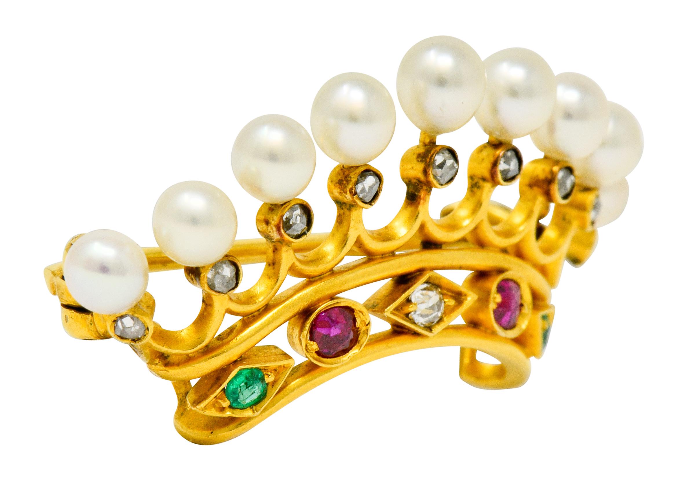 Brooch is designed as a pierced crown with each tine as a scalloped fishtail motif accented by rose cut diamonds

Each tine is topped by a round pearl, measuring from 3.3 to 3.5 mm, and are a well-matched cream body color with excellent