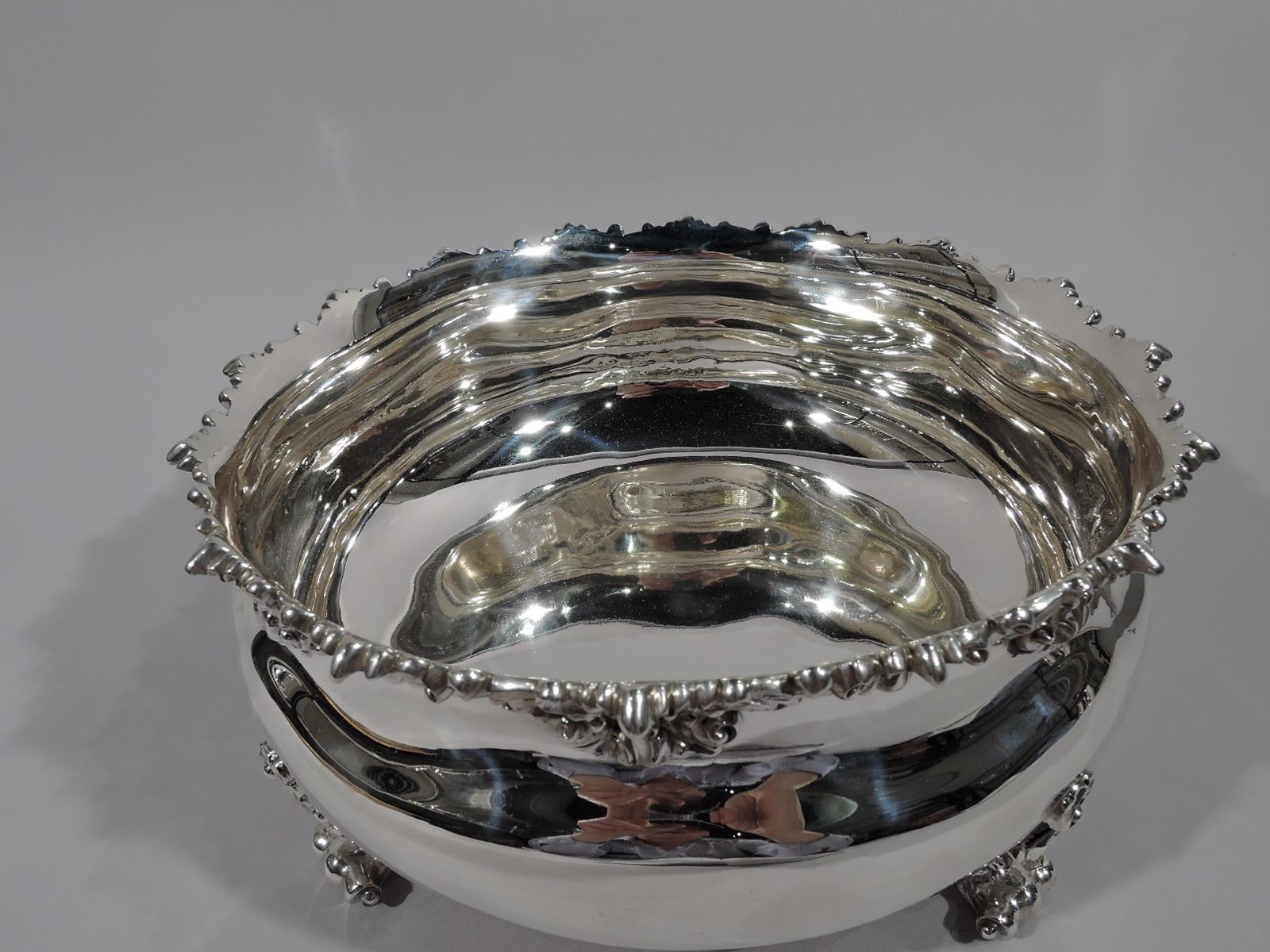 Fancy sterling silver cachepot. Retailed by Bailey, Banks & Biddle in Philadelphia, circa 1890. Bellied with four leafy-scroll volute-scroll supports. Rim applied with same. A pretty centerpiece bowl, perfect for flowers. Fully marked including