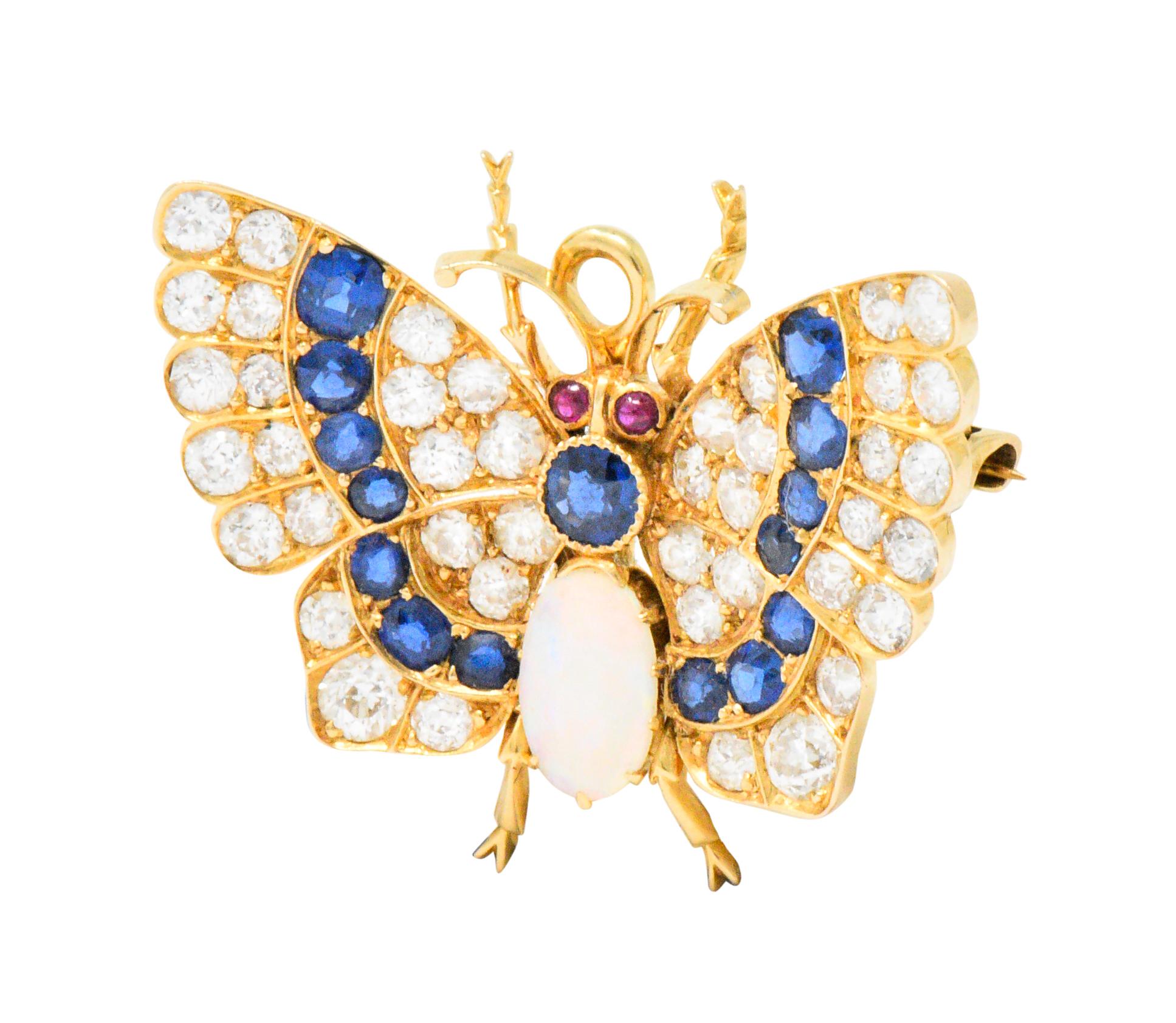Featuring a butterfly with round ruby eyes and a white opal body that measures approximately 8.5 x 5.0 mm with excellent play-of-color and full spectrum

Round and cushion cut sapphires adorn the body and wings, weighing approximately 1.65 carats