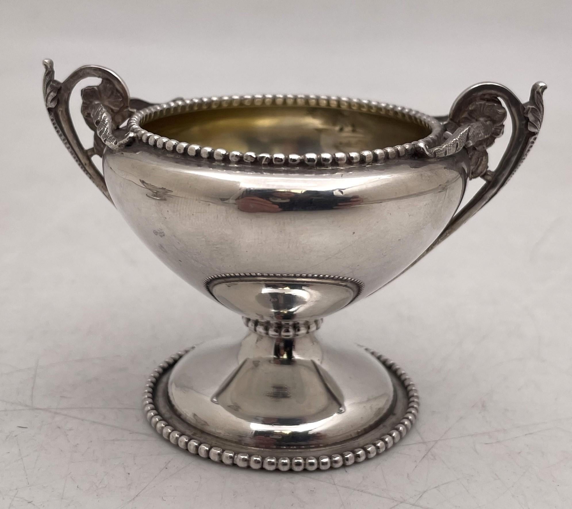 Bailey & Co. set of 4 coin silver open salts, gilt inside, with beaded motifs at the base and rim, with handles adorned with leaves. They measure 3 1/4'' from handle to handle by 2 1/2'' in height, weigh 7.7 troy ounces, and bear hallmarks and a