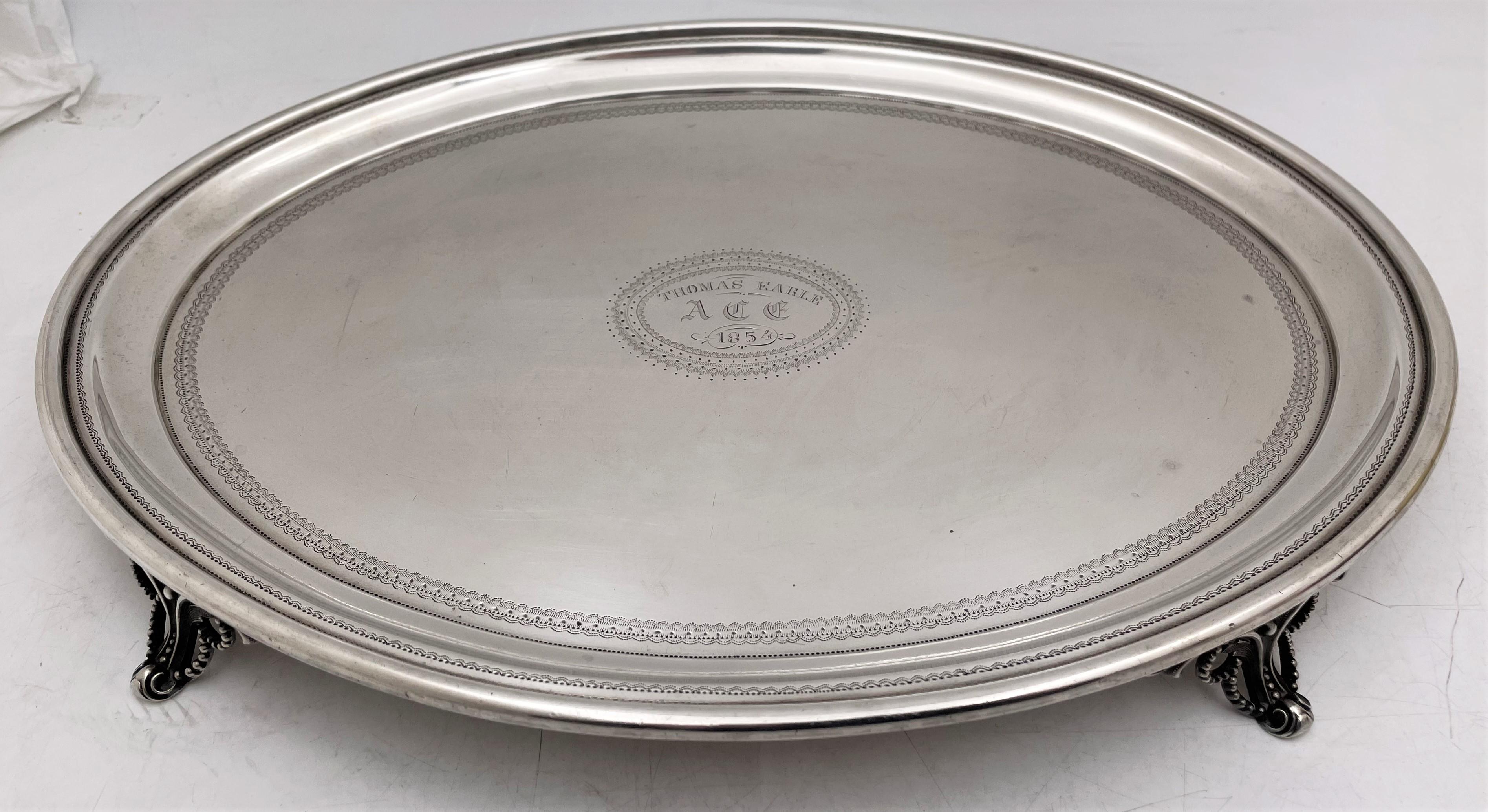 Bailey & Co., sterling silver salver or dish standing on 4 legs, from the early 1850s, with delicate, engraved motifs adorning the dish. It measures 14'' in length by 10 1/2'' in width by 1 1/8'' in height, weighs 29.9 troy ounces, and bears