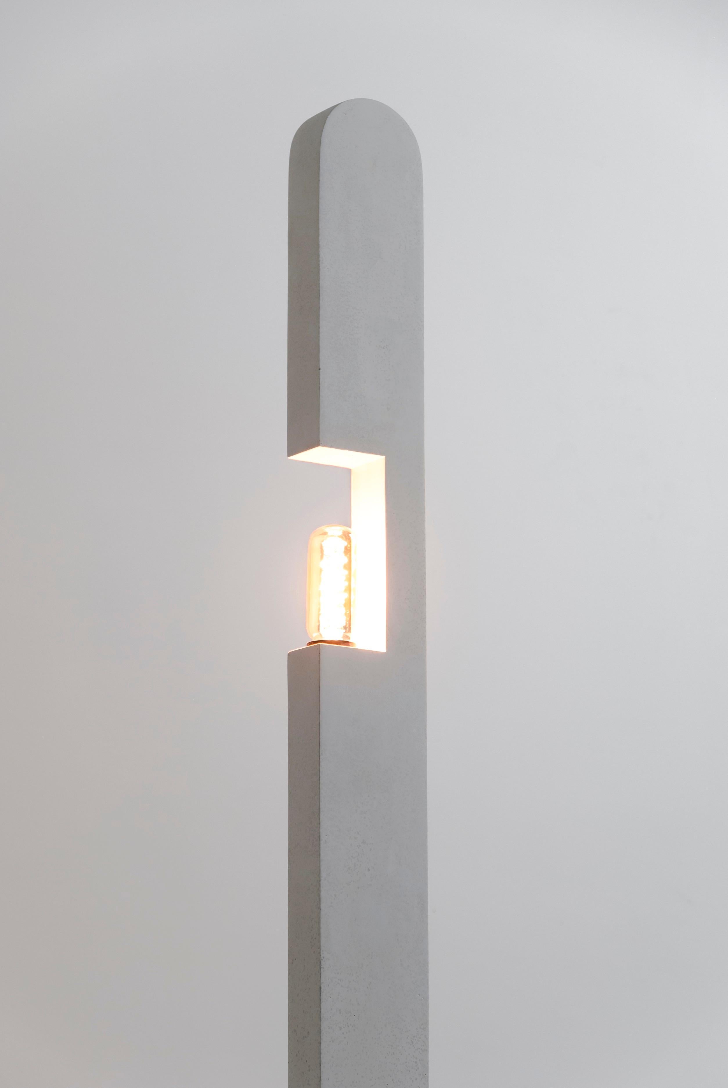 This minimalistic floor lamp is handmade by emerging artist and designer Bailey Fontaine. The Pillar Floor Lamp is meant to mimic architectural forms, and the feeling of viewing lights through a window in a big city. Bailey Fontaine's sculpting