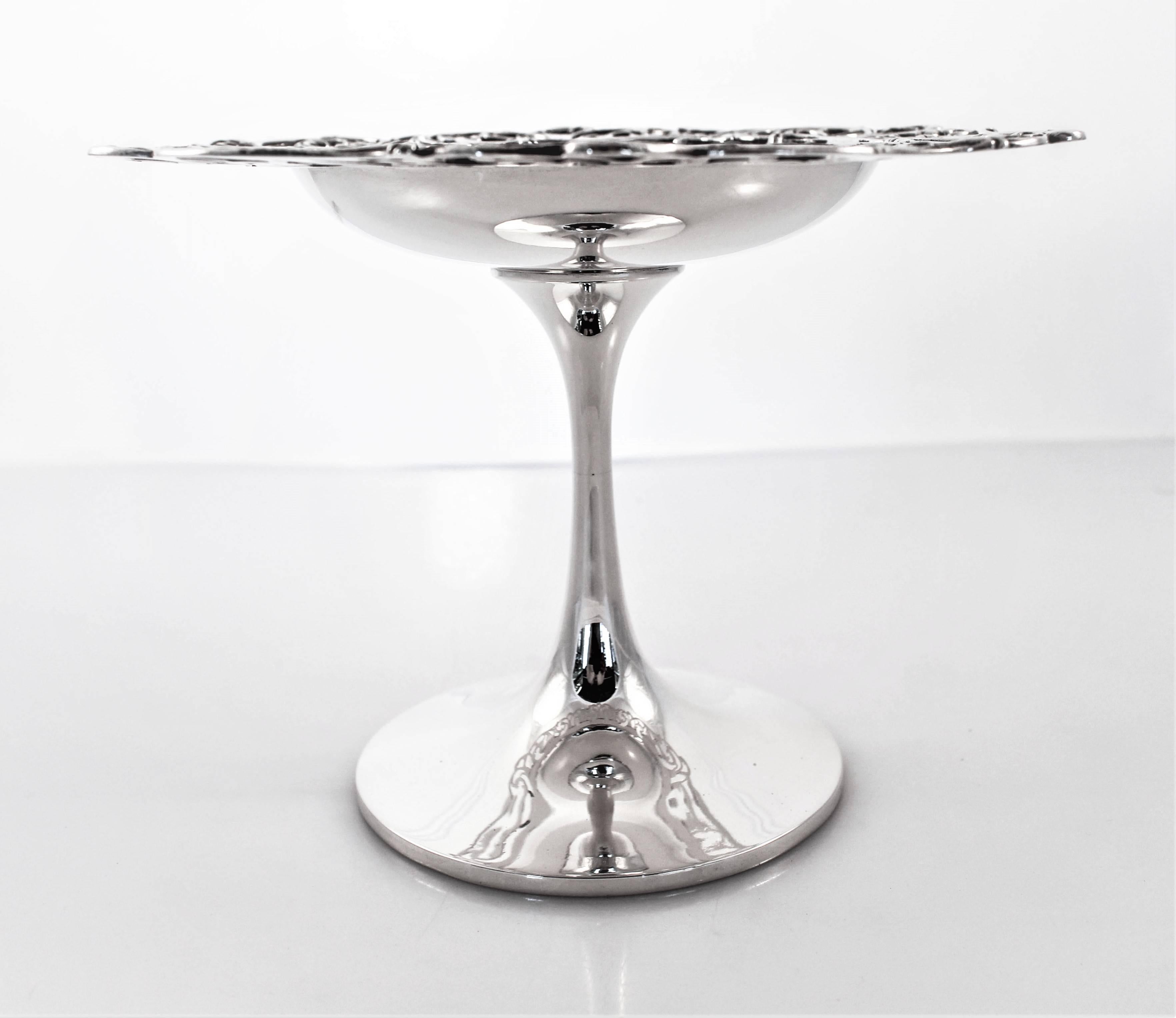 It’s where traditional meets modern; the best of both worlds. A two inch ornate openwork border encircles the top of this compote while the stem and base are modern and without design. A beautiful hand engraved monogram is in the center. This piece