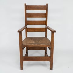 Baillie Scott for J P White. Arts & Crafts oak & rush seat ladder back armchair.