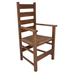 Baillie Scott for J P White. Arts & Crafts oak & rush seat ladder back armchair.