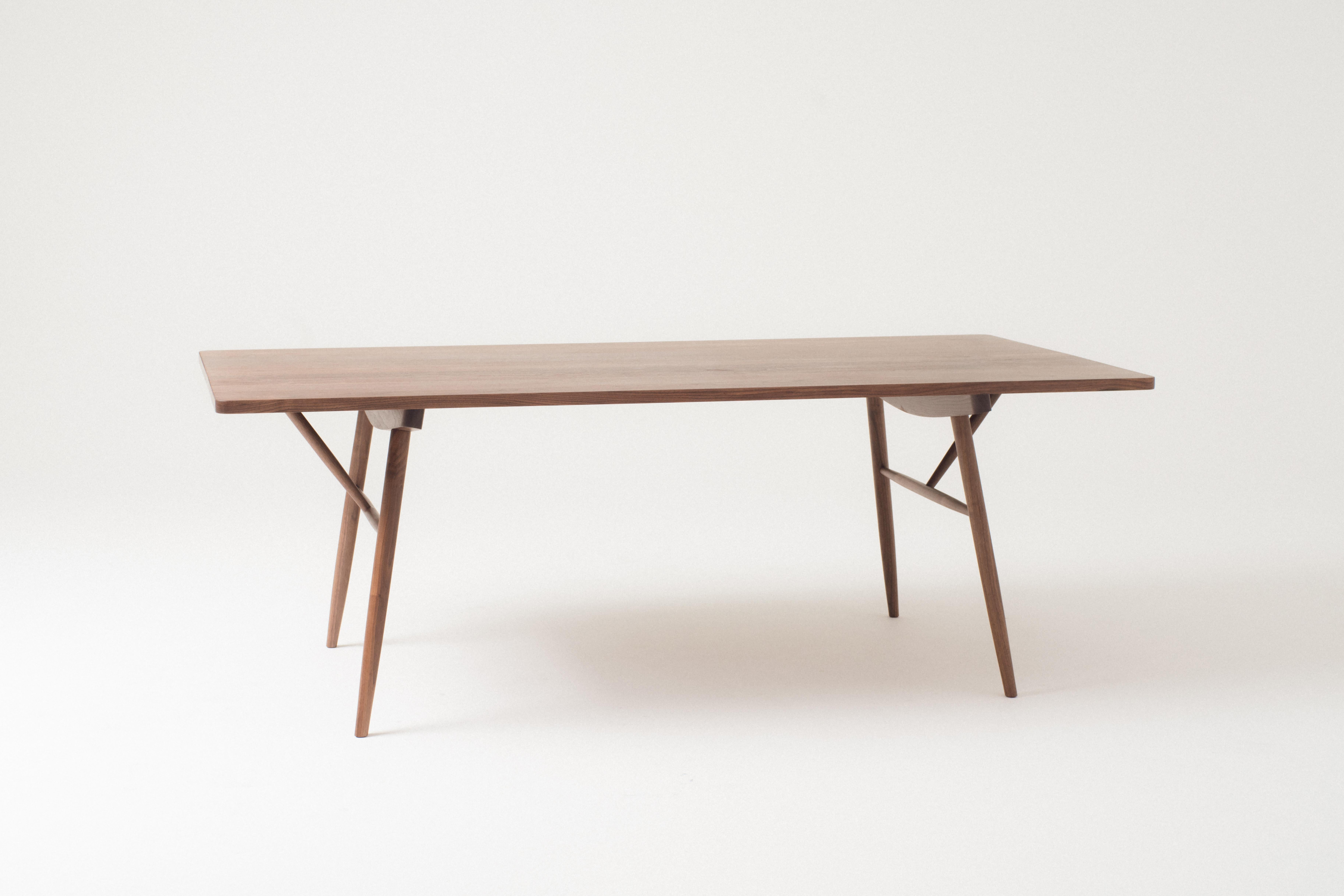 The Bainbridge Family Table was inspired by bridge truss structures and Shaker furniture. While lightweight and graceful in form, the Bainbridge is extremely sturdy with the bracing reinforcing the angled legs underneath the cantilevered top. Each