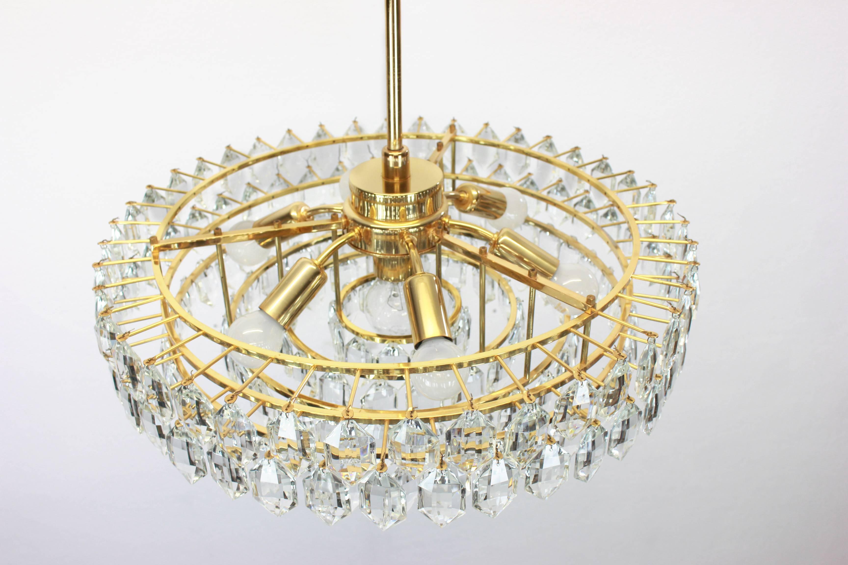 A stunning six-tier chandelier by Bakalowits & Sohne, Austria, manufactured in circa 1960-1969. A handmade and high quality piece. The ceiling fixture and the frame are made of gilt brass and has six rings with lots of facetted crystal glass