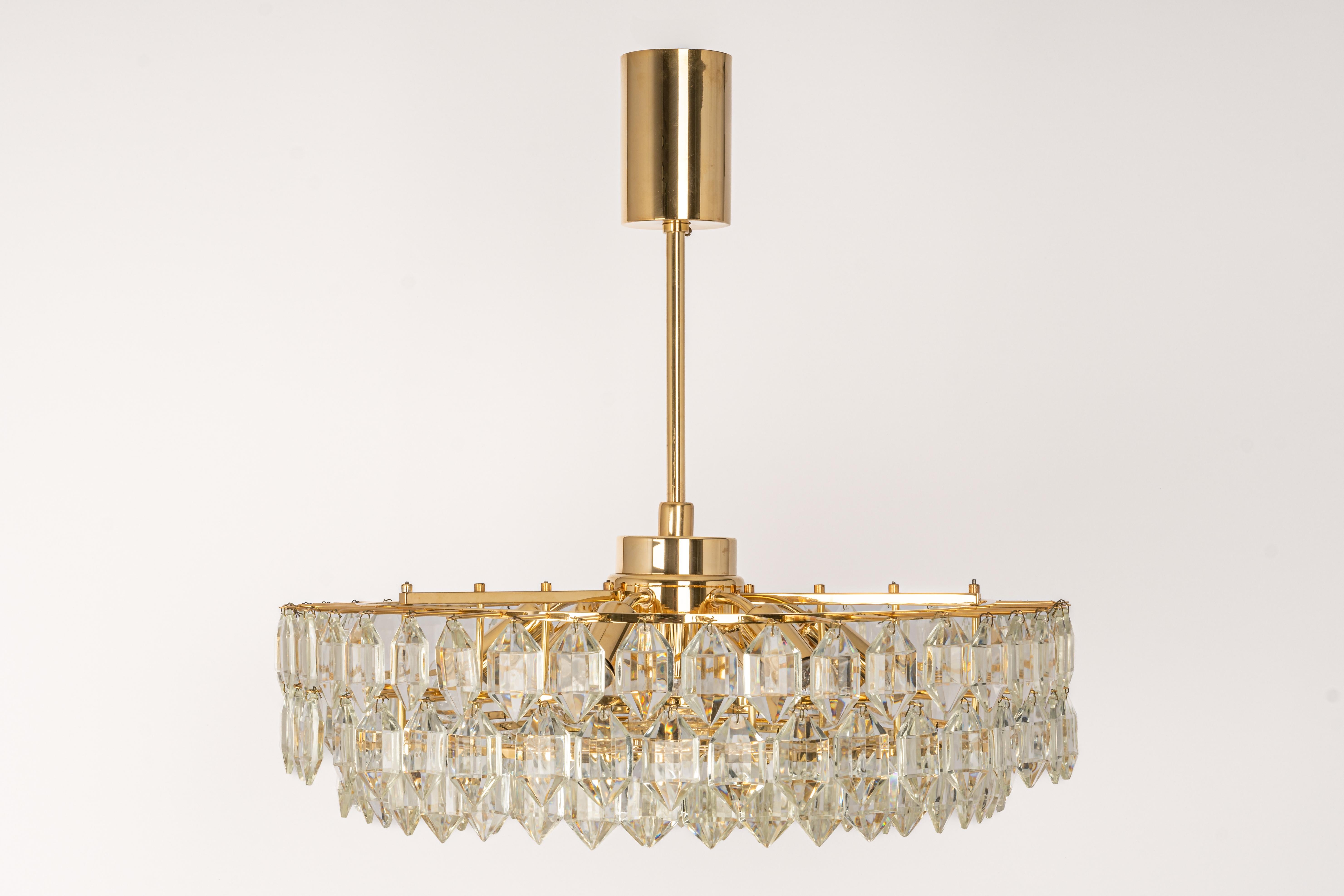 A stunning six-tier chandelier by Bakalowits & Sohne, Austria, manufactured in circa 1960-1969. A handmade and high-quality piece. The ceiling fixture and the frame are made of gilt brass and have five rings with lots of facetted crystal glass
