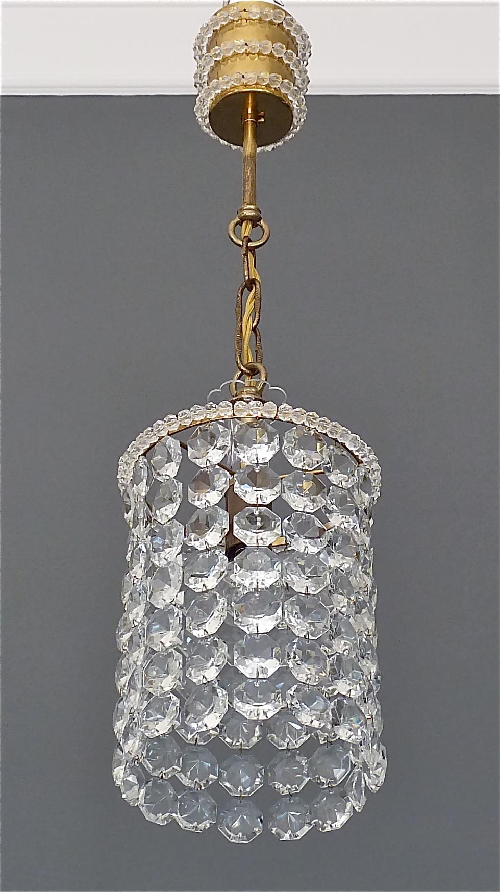 Precious petite midcentury chandelier made by the famous company Bakalowits, Vienna, Austria, circa 1955. The chain hanging height adjustable pendant lamp is made of patinated brass and lots of octagonal cut-glass crystal beads and pearls. The