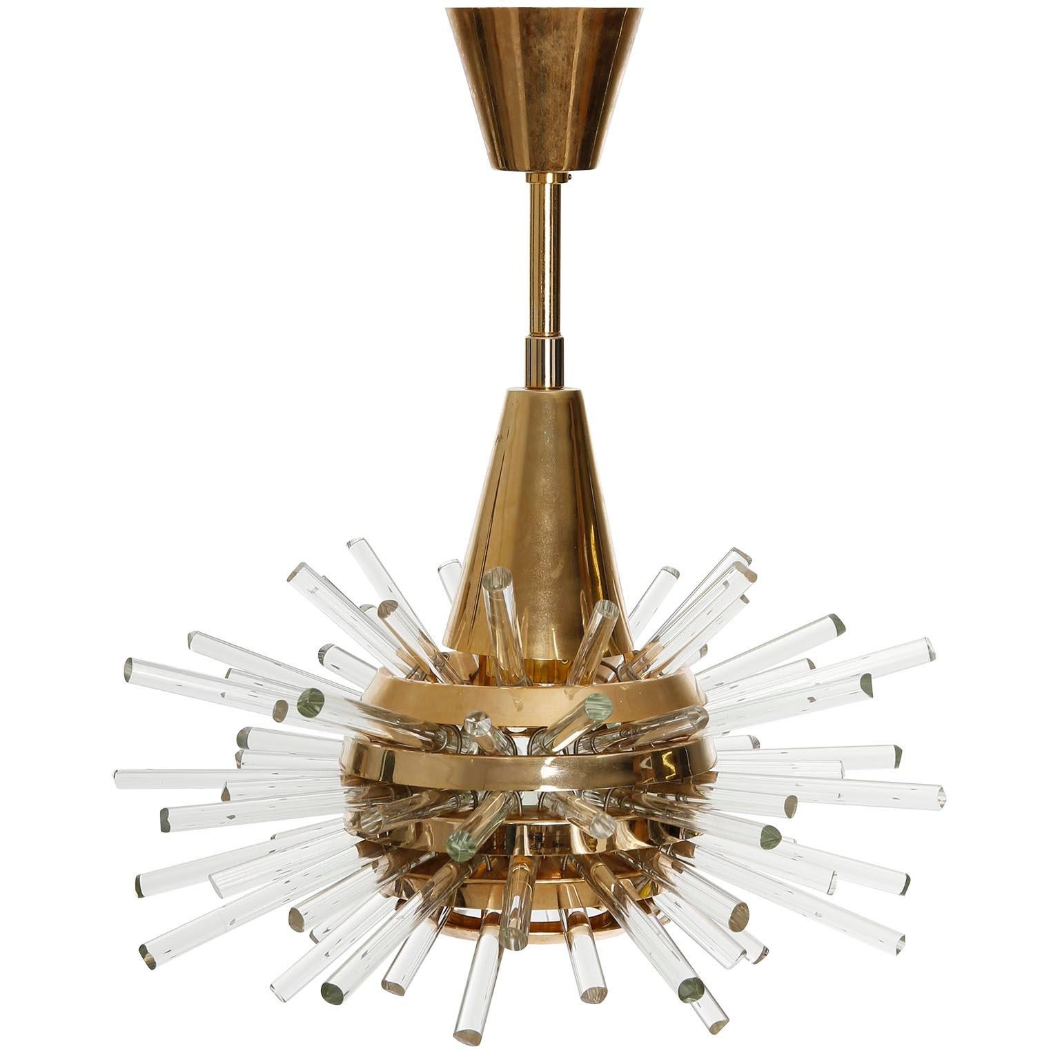 A fantastic sputnik chandelier or pendant light by Bakalowits & Sohne, Austria, manufactured in midcentury, circa 1970 (late 1960s or early 1970s).
A layered multi-tier structure made of gilt solid brass rings and glass rods with faceted ends in
