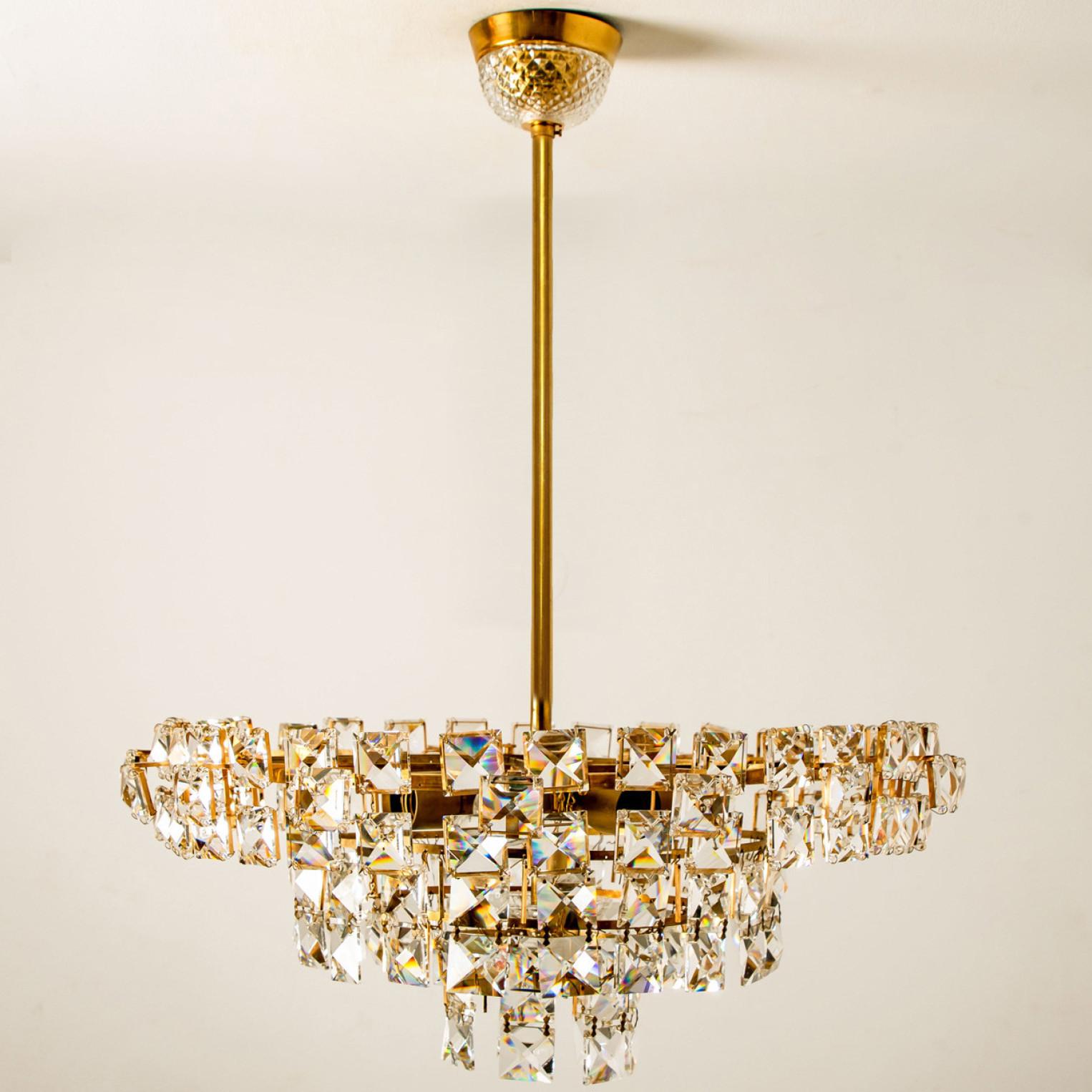 Very elegant chandelier by Bakalowits & Sohne, Austria. The chandelier is manufactured in circa 1960. With huge gem-like crystals and gilded brass frame. The crystals are meticulously cut in such a way that radiate the light of the bulbs in