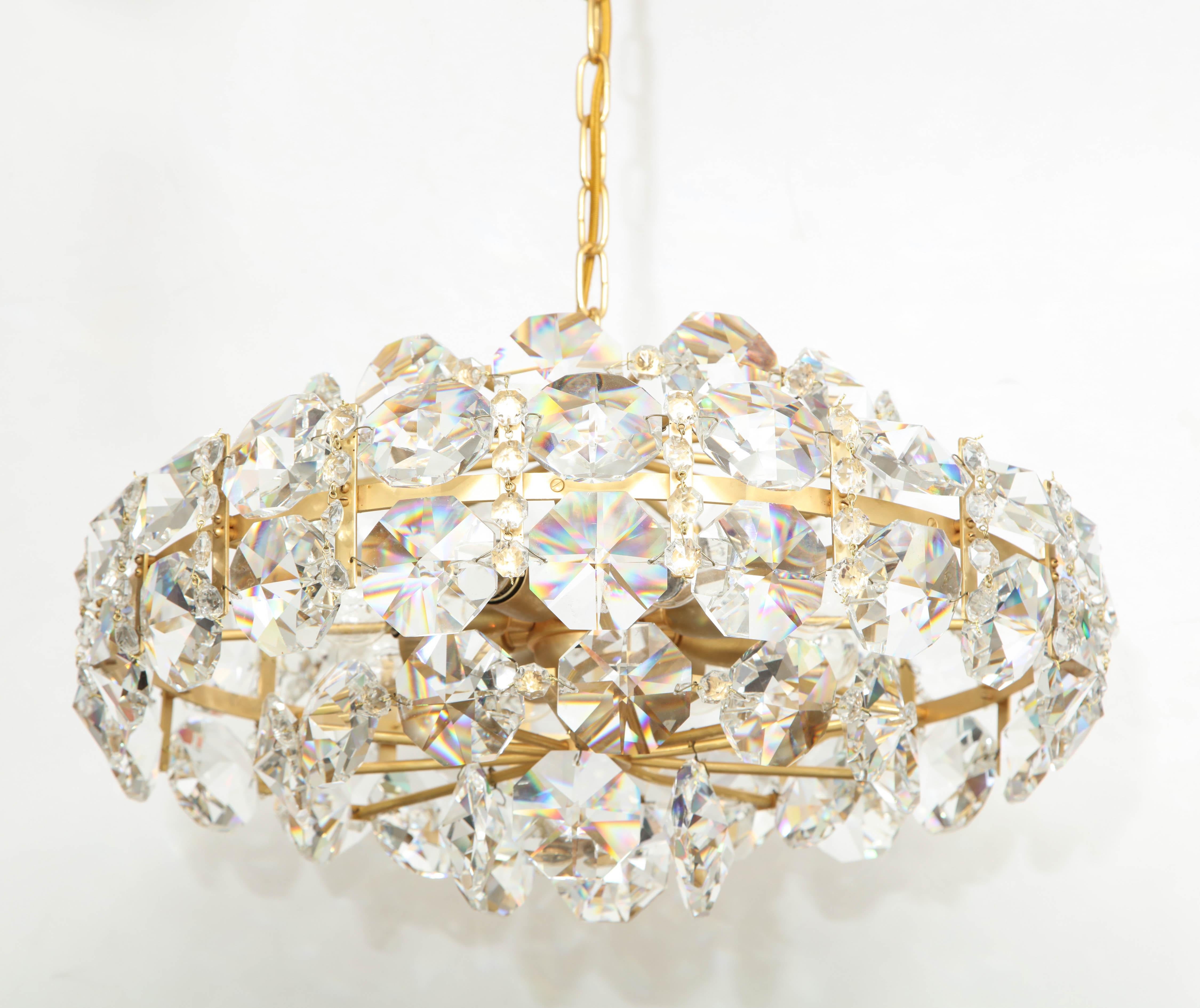 Dramatic Scandinavian Modern chandelier featuring large-scale octagonal faceted crystals on a 22-karat gold washed brass frame and chain. Rewired for use in the USA using 8 candelabra type bulbs.

Chandelier body measures 12 inches tall, 