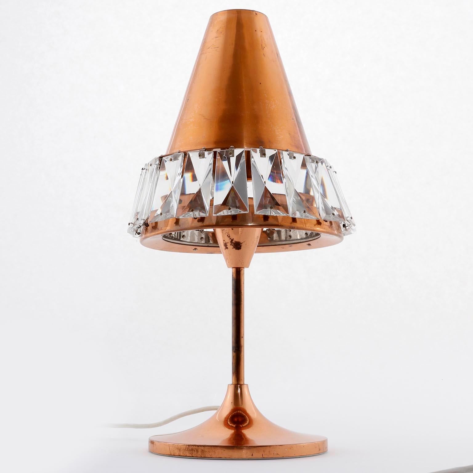 A rare and gorgeous table lamp by Bakalowits & Söhne, Vienna, manufactured in midcentury, circa 1960 (1960s or early 1970).  A cone shaped copper lamp shade with cut crystal glass sits on a stand with tulip base.
Lovely patina on copper. A few parts