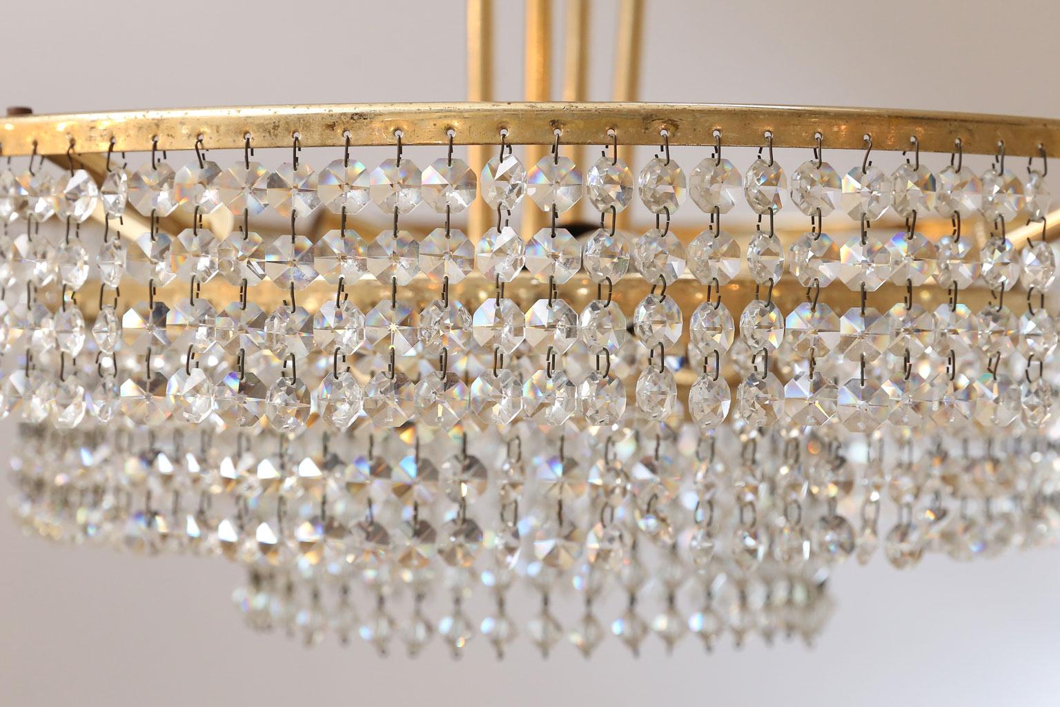 Bakalowits three-tier flush mount light: strings of cut-crystal prisms suspended from polished gilt-brass three tier frame, circa 1960s. Attributed to Bakalowits & Sohne of Vienna, Austria. Newly wired for use within the USA. Accommodates three