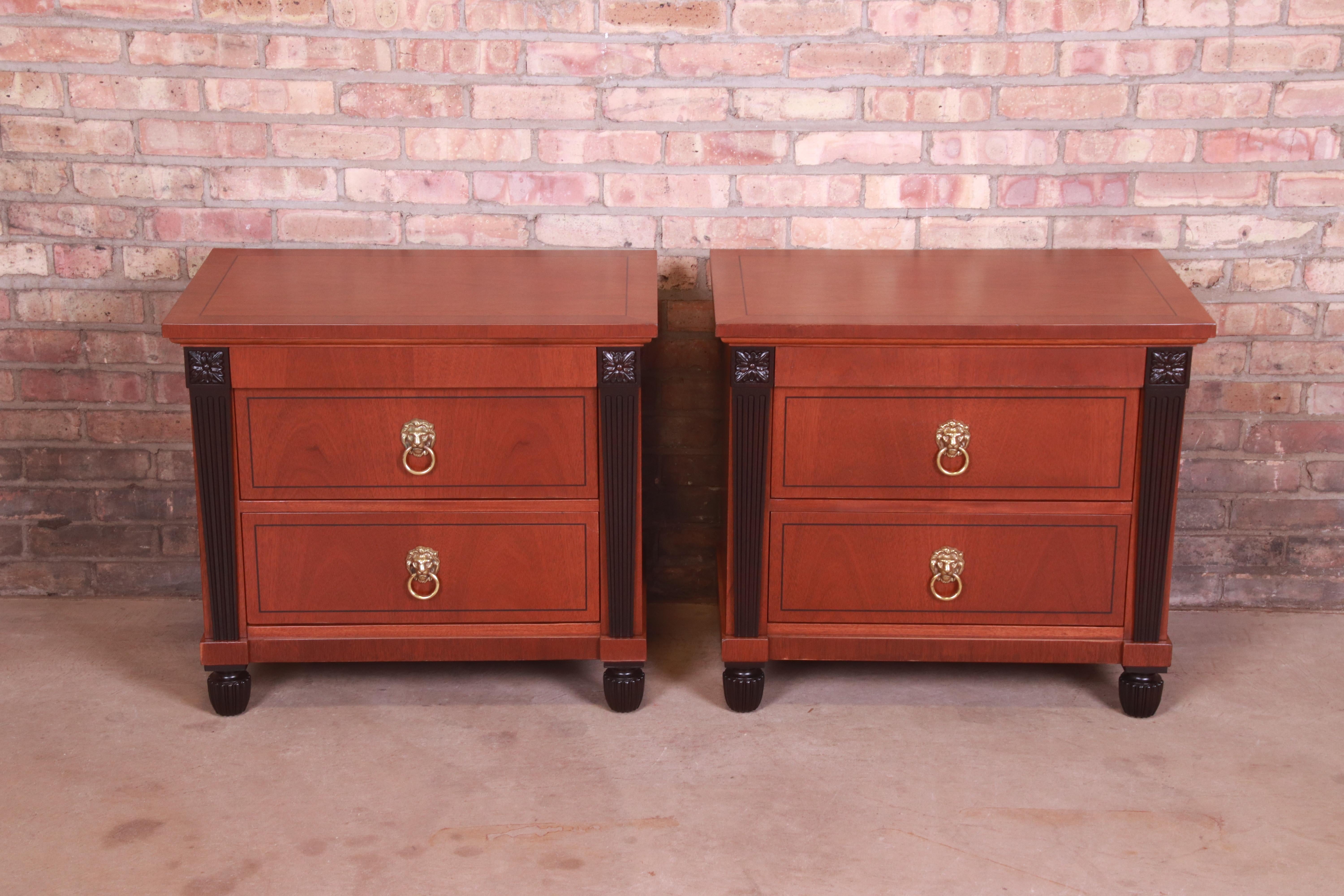 A gorgeous pair of neoclassical or Empire style nightstands or end tables

By Baker Furniture

USA, Circa 1980s

Carved mahogany, with ebonized columns and feet, and original lion head brass hardware.

Measures: 28