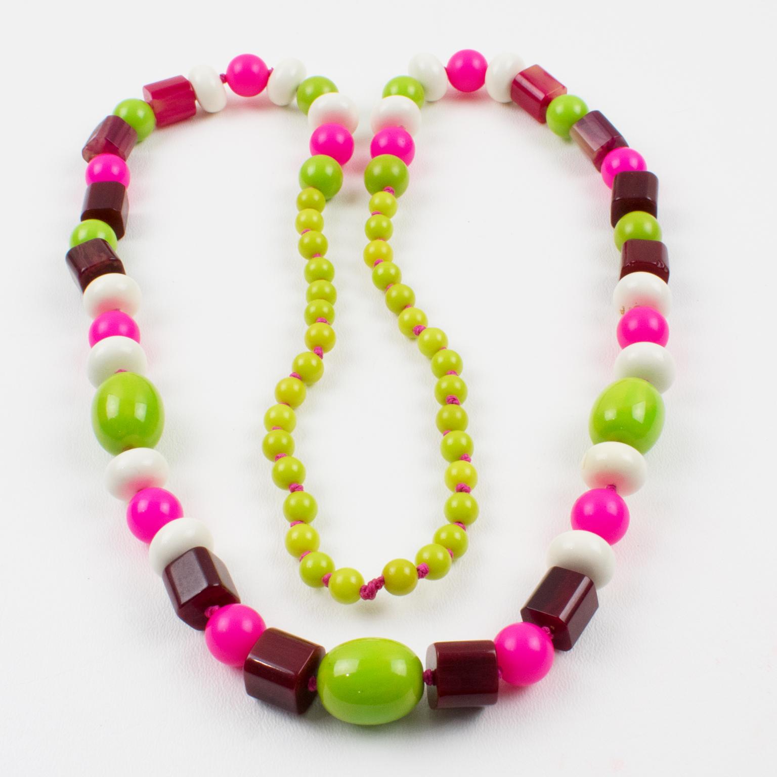 Playful extra-long Bakelite and Lucite beaded necklace. Assorted beads in various shapes: round, square stick, tomato, and ovoid. Mix and match flashy colors, apple green marble, hot pink, fuchsia, and custard marble contrasted with white Lucite