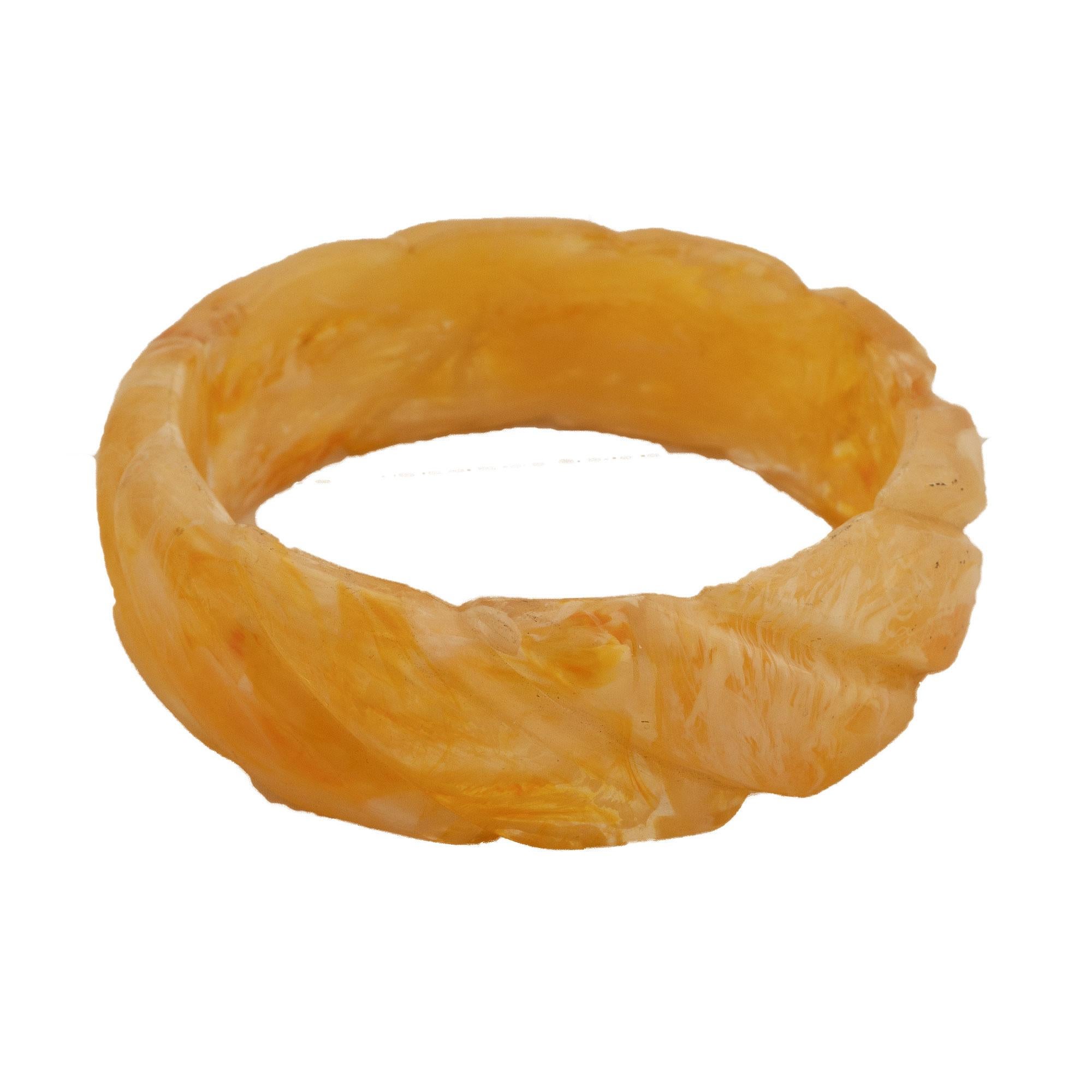 Women's Bakelite bangle with carved diagonal braid shape, transparent and honey color. For Sale