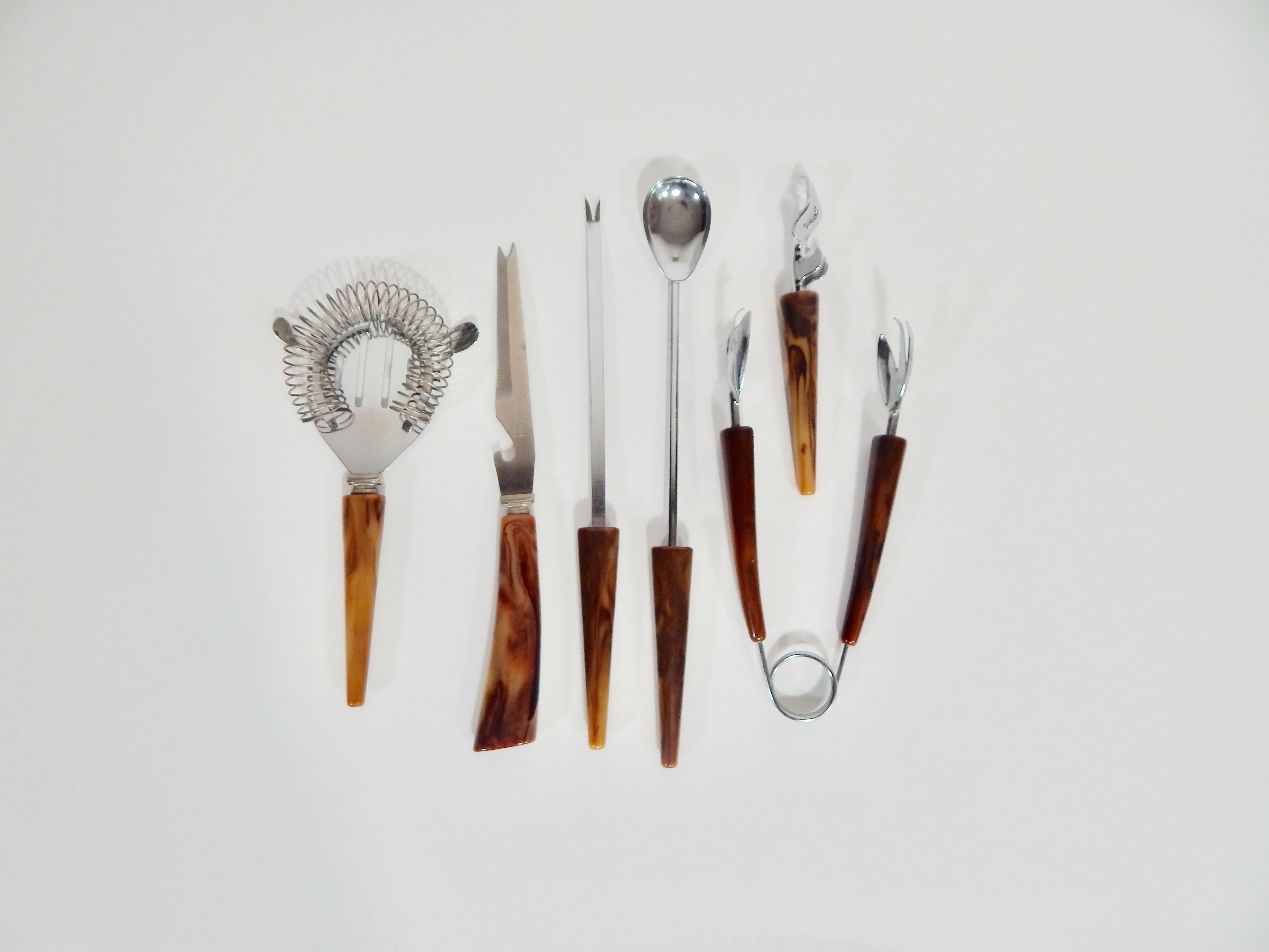 3 clear plastic bar utensils and a long handled spoon 6 Pieces of Vintage Bar Tools which consist of 2 pieces of bakelite bar utensils