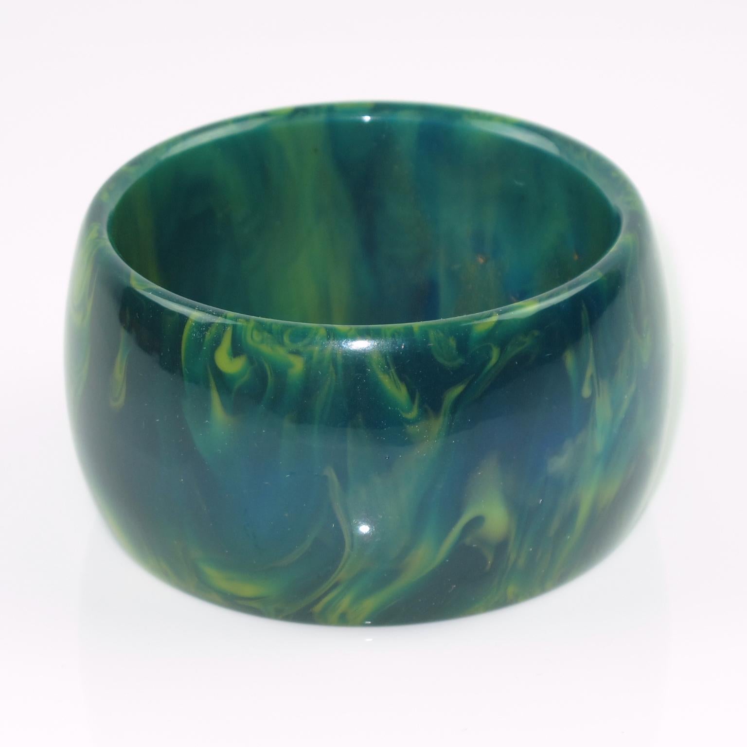 Gorgeous oversized blue-moon marble Bakelite bracelet bangle. Chunky wide domed shape. Intense blue marble tone with green and white cloudy swirling. 
Measurements: Inside across is 2.5 in. diameter (6.4 cm) - outside across is 3.07 in. diameter