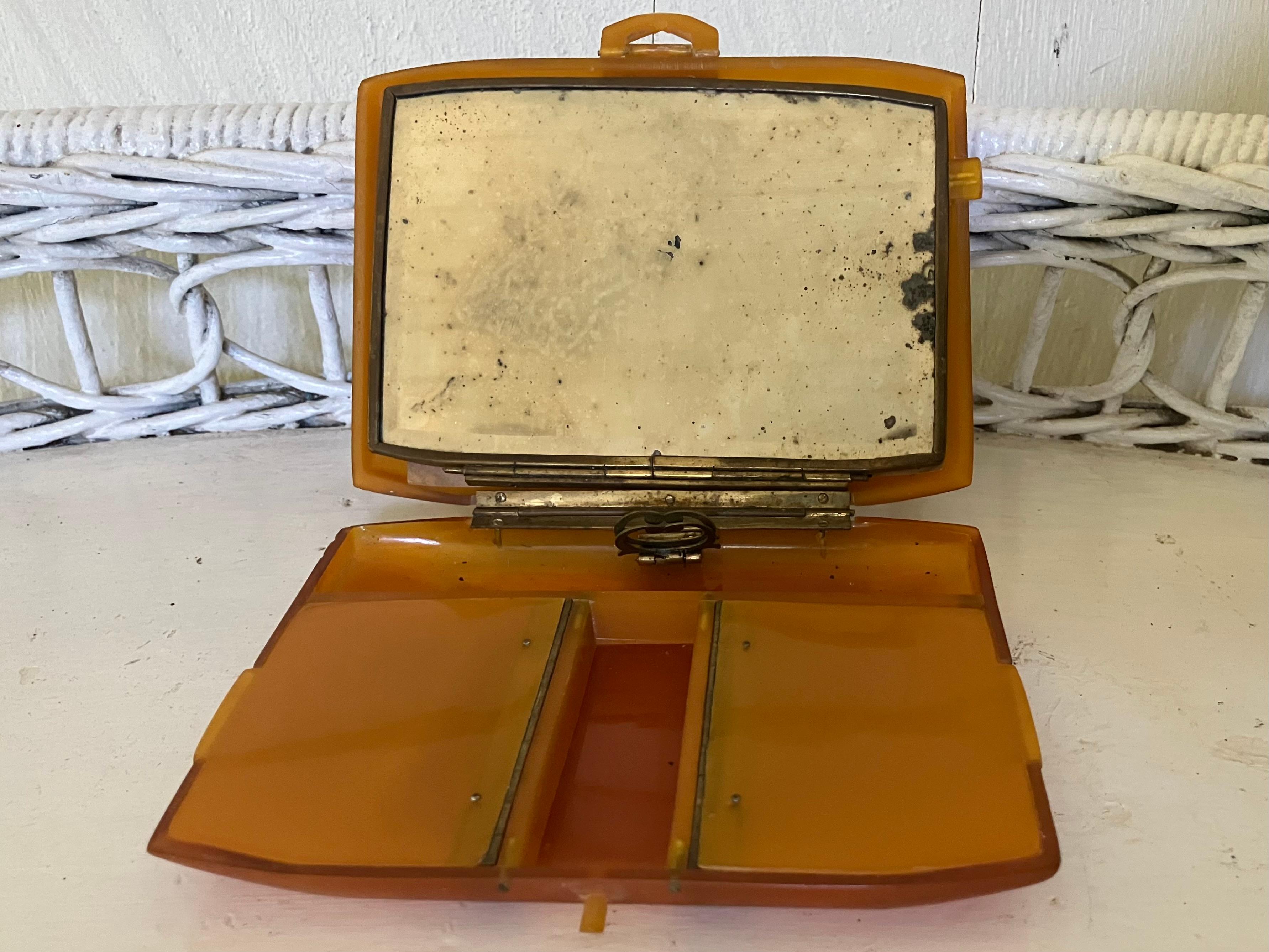 Bakelite minaudière box. Vintage Italian bakelite tortoise box with hinged mirrored removable lid, hinged lid double compartments and two open compartments. Originally a lady’s  makeup powder compact which holds paper blotter, lipstick, rouge and