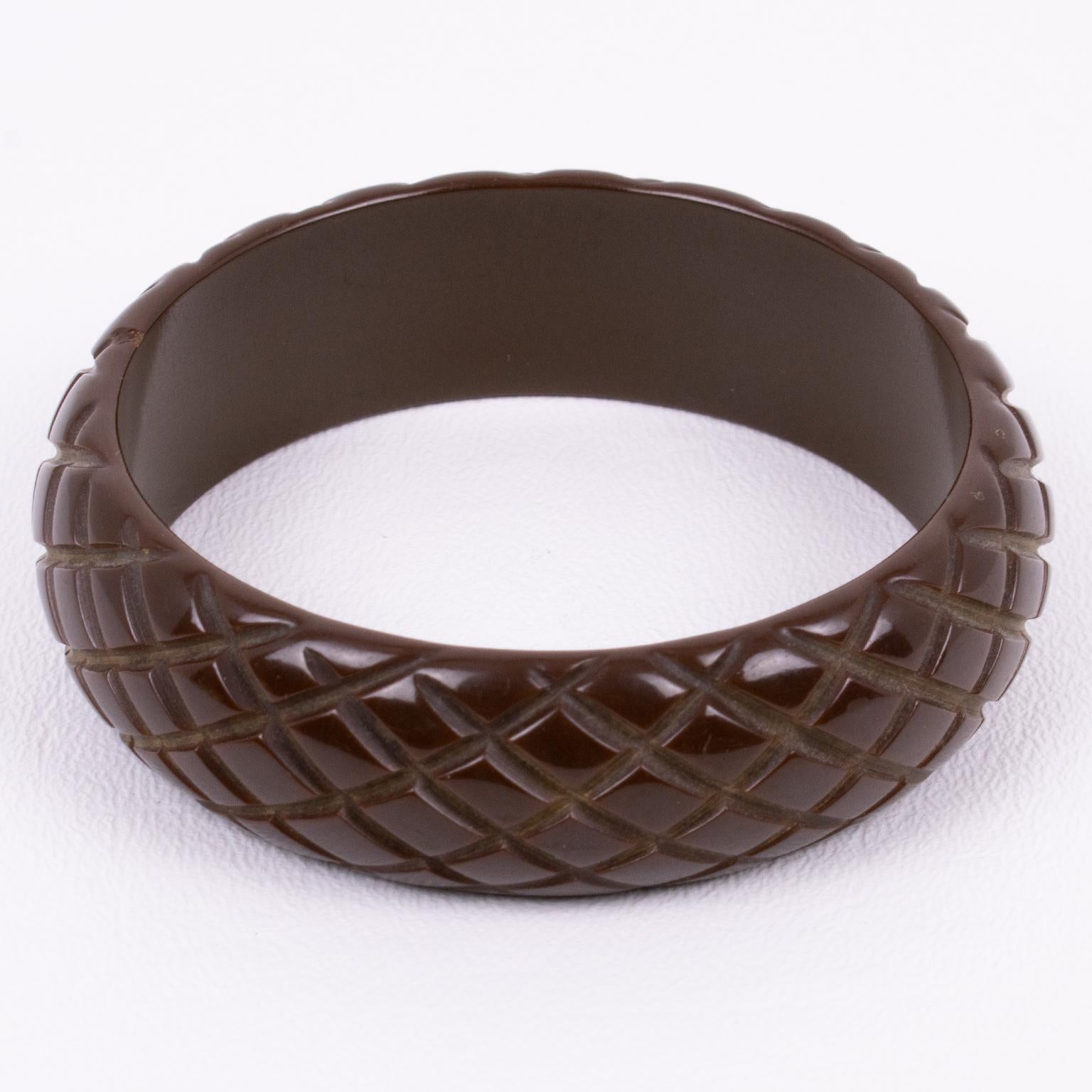 This stunning cocoa brown Bakelite carved bracelet bangle features a chunky domed shape with deep pineapple carving. Its bold and beautiful design displays stripes all around. The cocoa brown color is warm and intense.
Measurements: Inside across is