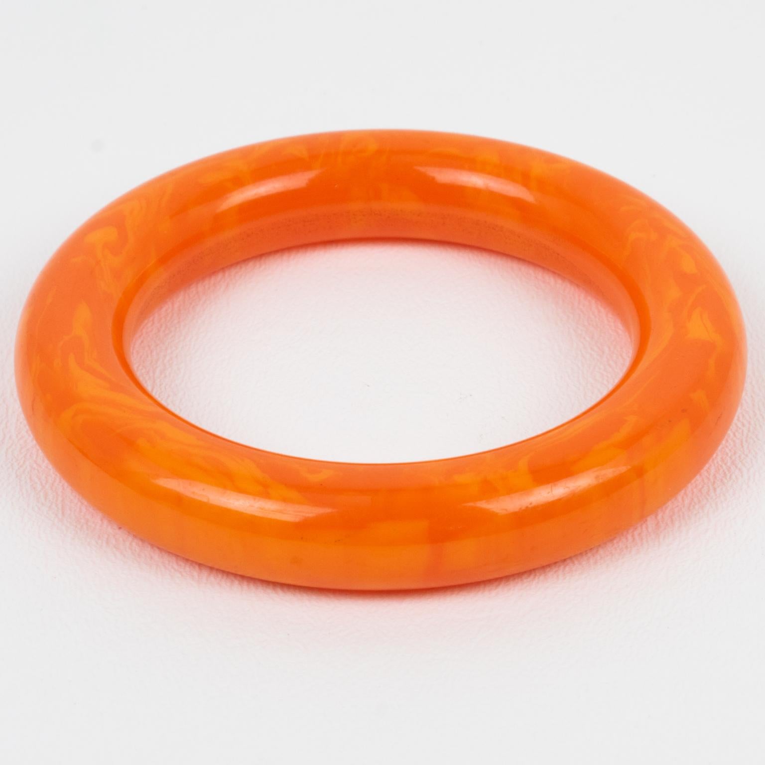 This lovely Bakelite bangle features a chunky tube shape with an intense tangerine orange color and cloudy cantaloupe swirling.
Measurements: Inside across is 2.50 in diameter (6.3 cm) - outside across is 3.63 in diameter (9.2 cm) - width is 0.63 in