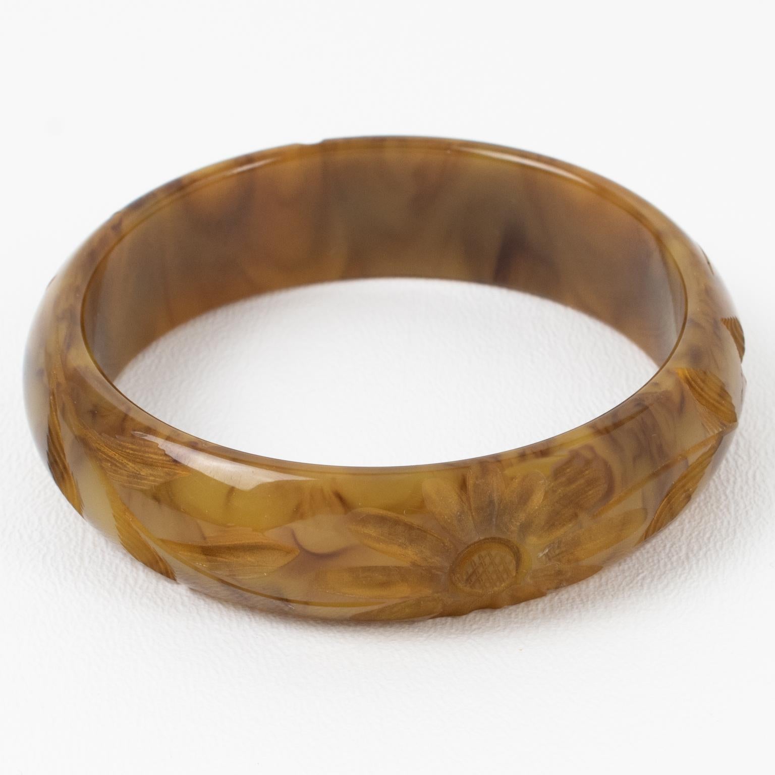This is a lovely yellow and brown marble Bakelite carved bracelet bangle. It features a chunky domed shape with deep floral carving all around. The color is an intense yellow-beige custard marble tone with toffee brown cloudy swirling.
Measurements: