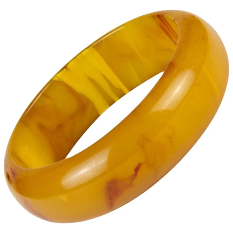 Bakelite bracelet, France, around 1920

Ambercoloured bakelite bangle, 1920s
inside diameter: 6,5 cm/ 2.55 Inch
Width: 8 cm /3.14 Inch
Height: 2 cm /0.79 Inch
Color:
Yellow
Material:
other plastics
Known defects:
Slight signs of age-related wear and