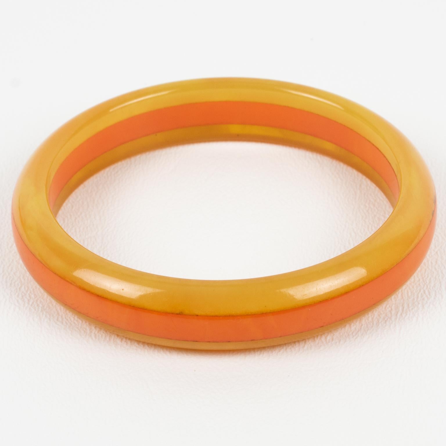 This lovely bi-color marble Bakelite laminated bracelet bangle features a chunky domed shape with a multi-layer design. The colors are a sunny, intense, warm orange tone with lighter milky swirling combined with a warm yellow curry marble tone.
The