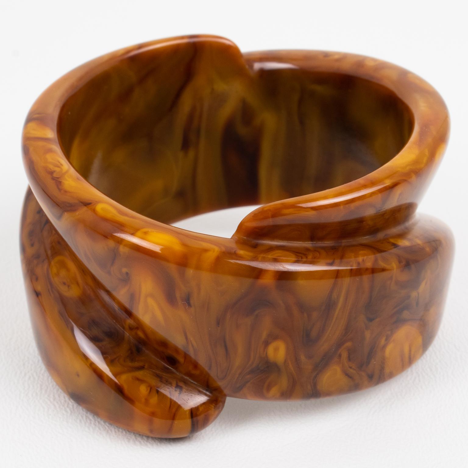 This is a spectacular hand-carved chocolate sundae marble Bakelite bracelet bangle. The piece boasts a massive extra-wide shape with an incredible carved coiled design. The bangle has an intense chocolate brown color with cloudy swirling and looks