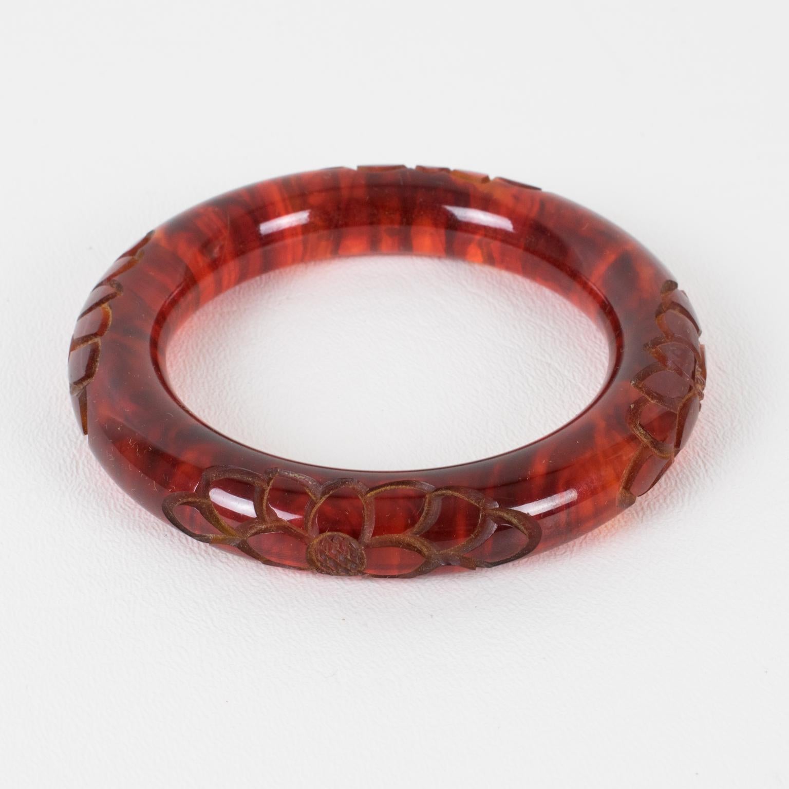 Stunning red tea amber marble Bakelite bracelet bangle. Chunky rounded domed shape with a deep floral carving all around. Intense orange-red color with lots of cloudy swirling and translucency.
Measurements: Inside across is 2.50 in diameter (6.4