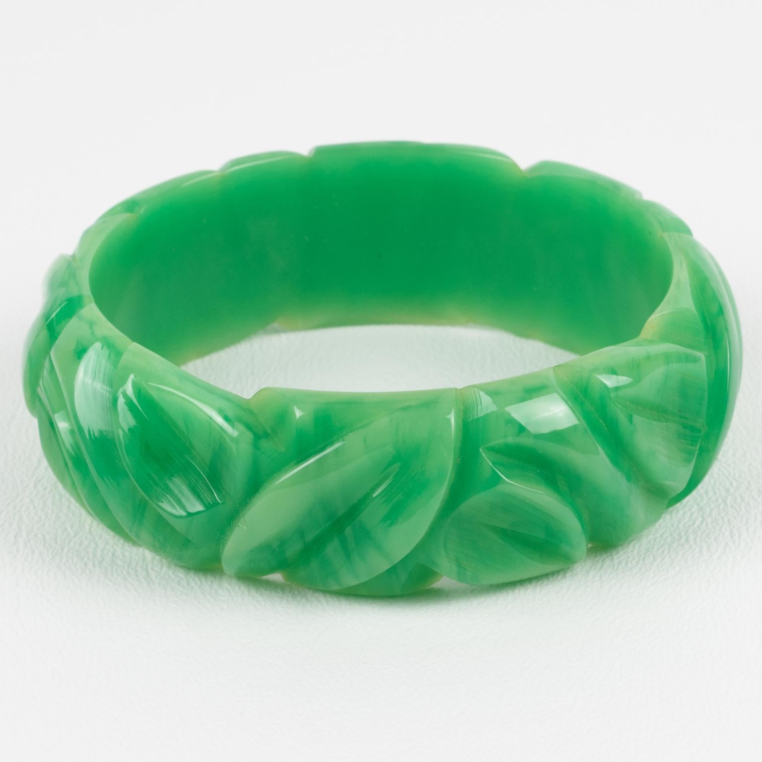 This is a gorgeous milky turquoise marble Bakelite carved bracelet bangle. It features a chunky domed shape with deep geometric carving all around. The color is an intense green marble tone with milky cloudy swirling.
Measurements: Inside across is