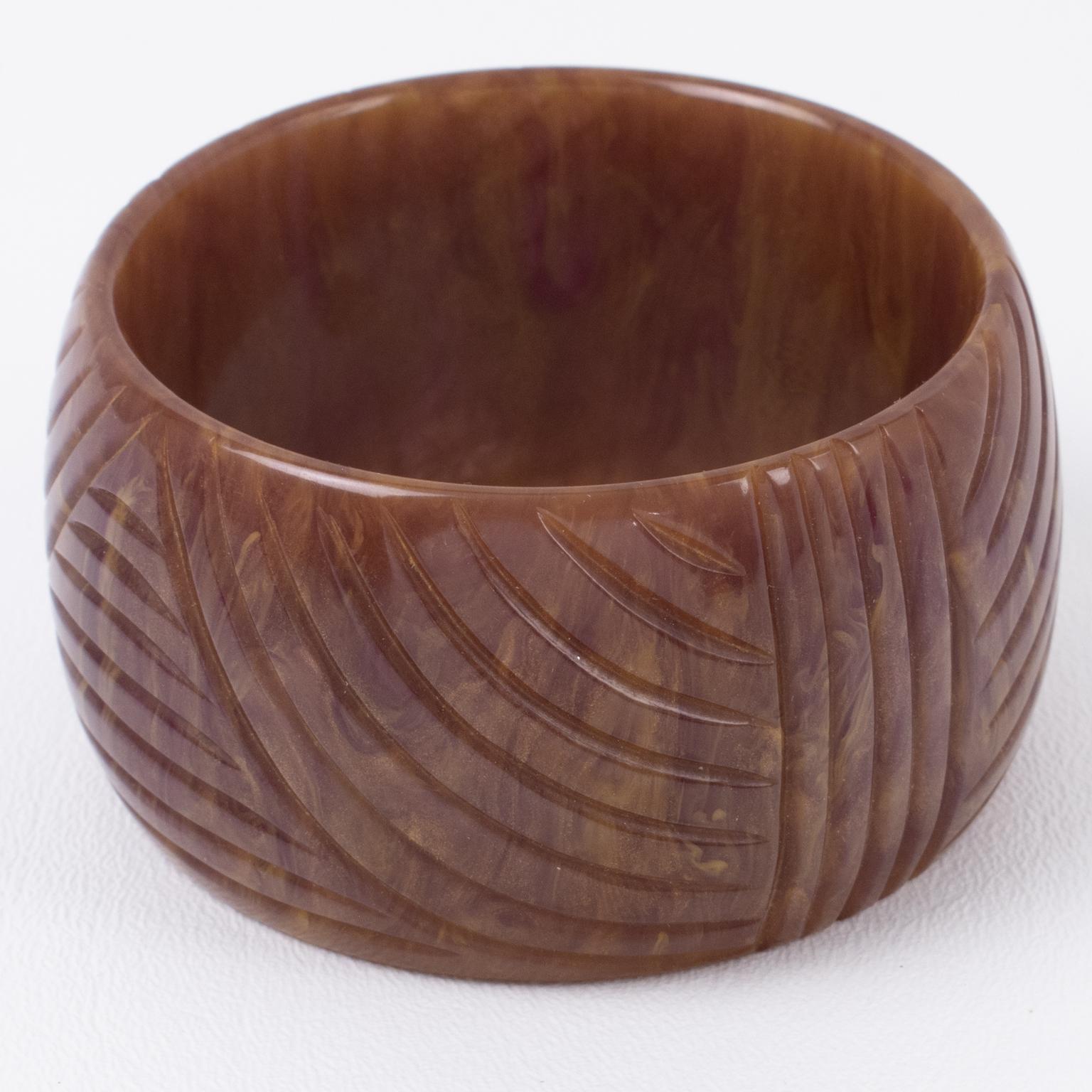 This is a spectacular purple stardust marble Bakelite carved bracelet bangle. It features a chunky oversized domed shape with a geometric carving design. The color is an intense purple with milky swirling and gold dust inclusions. 
Measurements: