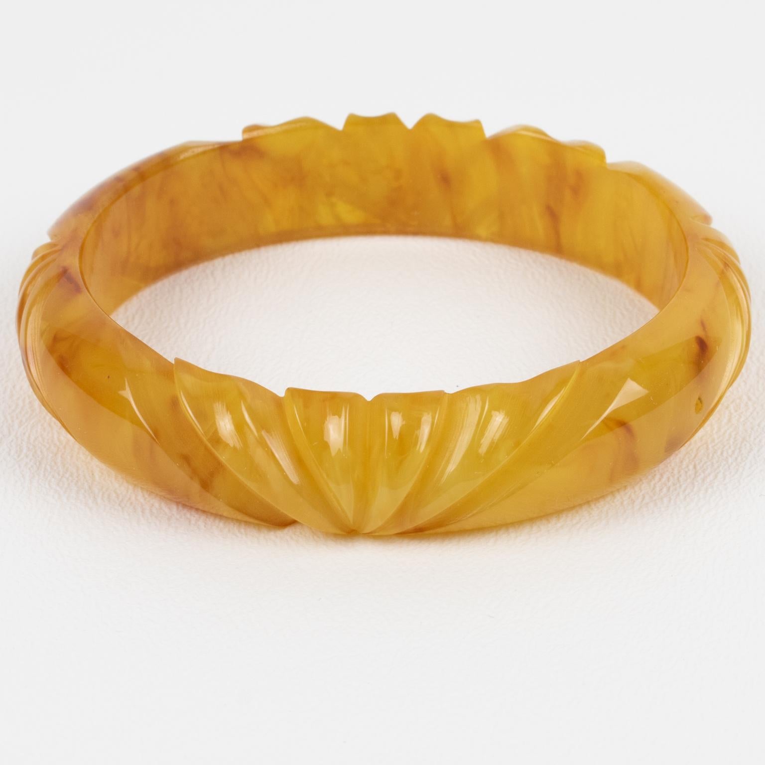 This is a lovely yellow-egg-yolk with red-wine marbling Bakelite carved bracelet bangle. It features a spacer domed shape with deep geometric carving all around. The color is an intense yellow egg yolk tone with red wine and white cloudy swirling.