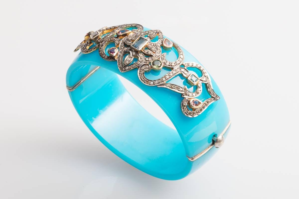 Brilliant blue Bakelite cuff bracelet with pave`-set diamonds and faceted tourmalines of various cuts and color, set in an oxidized sterling silver and applied to the bracelet.  Sterling push clasp.   Oval shape keeps the bracelet from turning. 