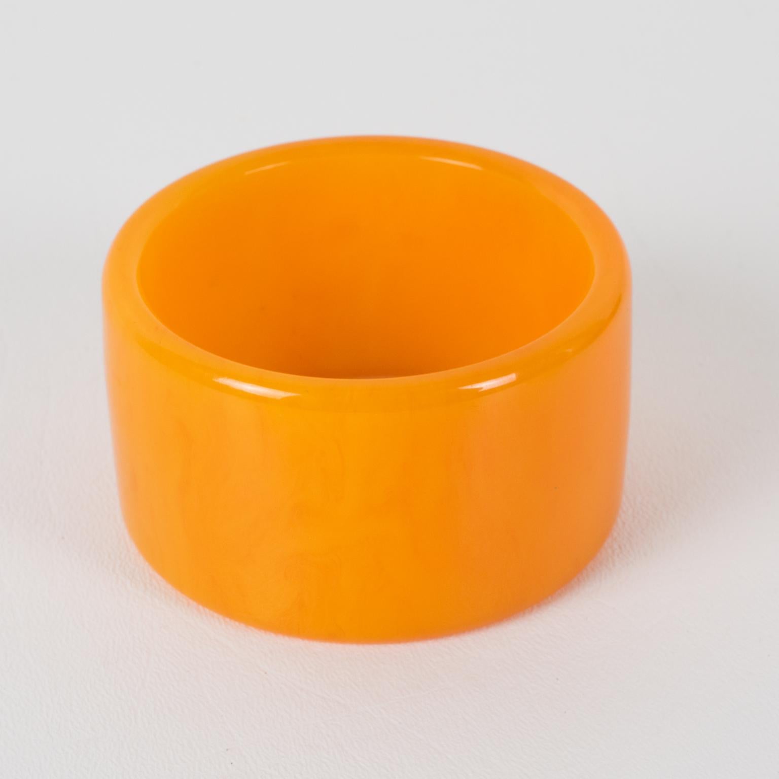 This lovely milky orange tangerine marble Bakelite bracelet bangle boasts a massive wide sliced shape with an intense soft orange color with cloudy milky swirling and translucency. 
Measurements: Inside across is 2.57 in diameter (6.5 cm) - outside