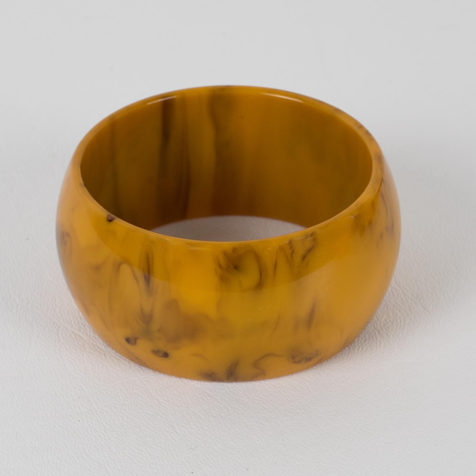 Superb butterscotch and black marble Bakelite bracelet bangle. Oversized wide domed shape. Intense butterscotch color with cloudy black swirling also called Mississippi Mud or Swamp color. 
Measurements: Inside across is 2.57 in. diameter (6.5 cm) -