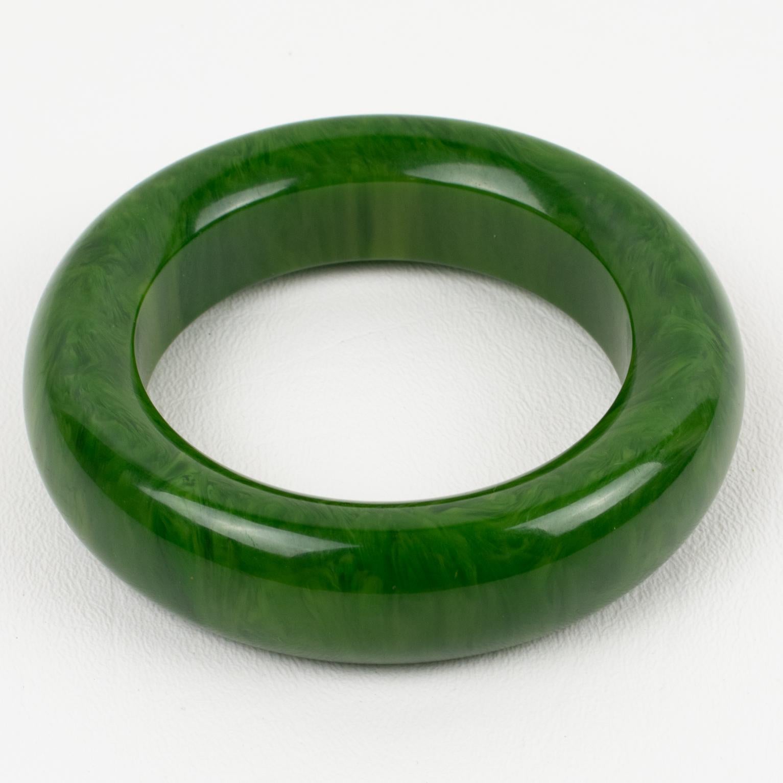 Spectacular green moss marble Bakelite bracelet bangle. Chunky domed shape with an extra thick wall. Intense green marble tone with lighter green swirling. 
Measurements: Inside across is 2.44 in. diameter (6.2 cm) - outside across is 3.63 in.