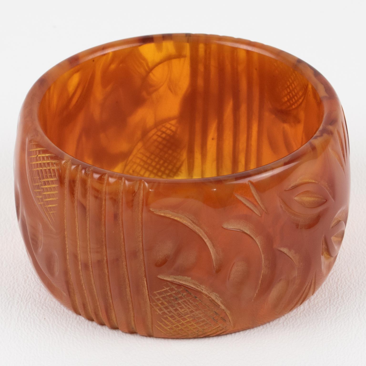 This is a lovely milky amber marble Bakelite carved bracelet bangle. It features a chunky oversized domed shape with a geometric carving design. The color is an intense amber tone with milky swirling and translucency. 
Measurements: Inside across is