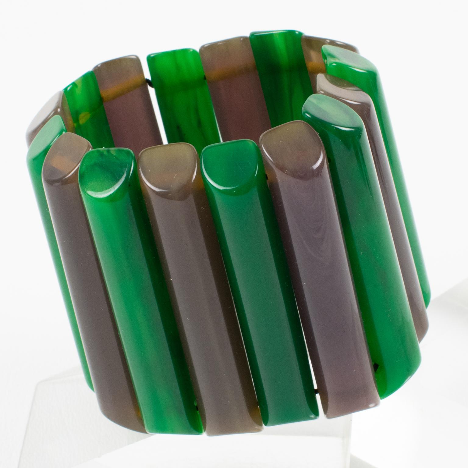 This is a remarkable Bakelite bracelet bangle that I think you'll love. The stretch design and oversized shape make it a rare find, and the carved sticks in alternating emerald green marble and dark mouse gray colors add to its unique appeal. It was