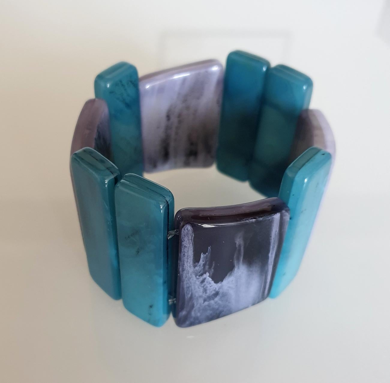 Mid Century Bakelite bracelet, France circa 1970s.
Some black veins on the Bakelite.
The blue elements are a little higher, and the gray ones not straight, 
giving a lot of style to the bracelet.
Excellent condition.