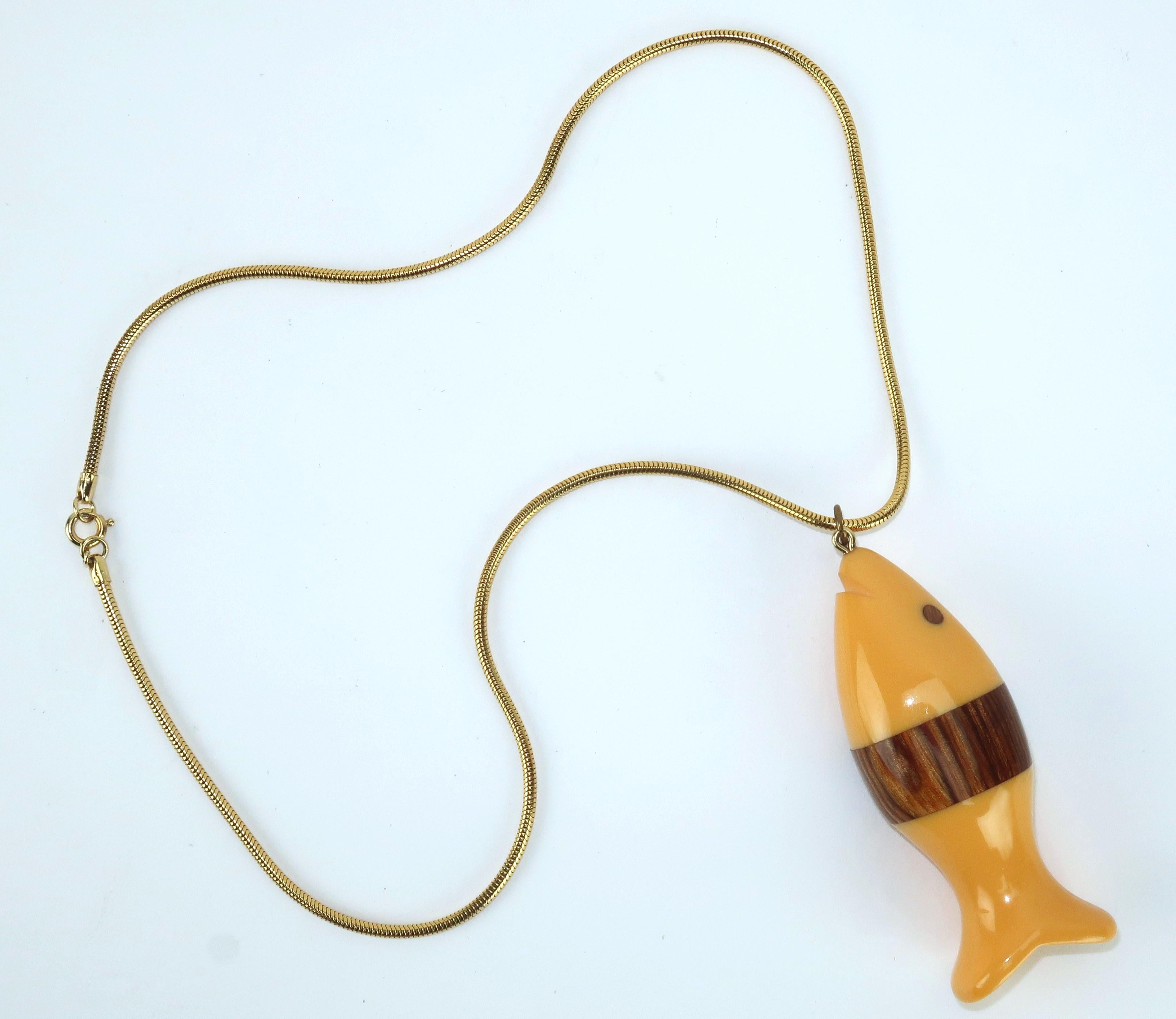 This little guy is quite a catch!  1960's bakelite fish pendant with wood accents suspended from a gold tone serpentine chain.  The chain is outfitted with a spring ring closure.  Don't let this one swim away!  Note:  this same pendant is pictured