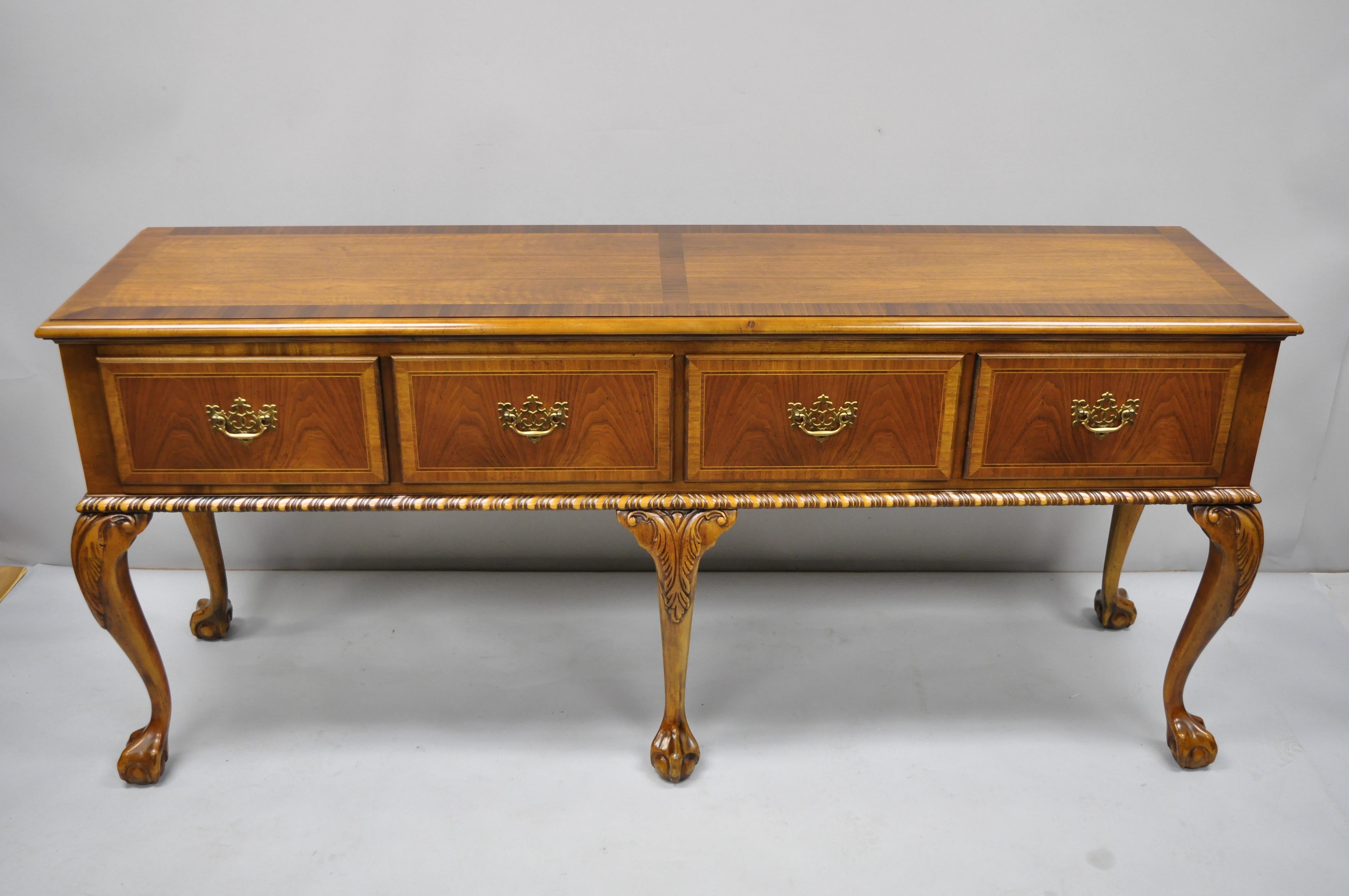 Baker 4-drawer ball and claw Chippendale mahogany banded sideboard buffet. Item features carved ball and claw feet, banded top and drawer fronts, custom glass top, beautiful wood grain, original label, 4 dovetail drawer, very nice vintage item,